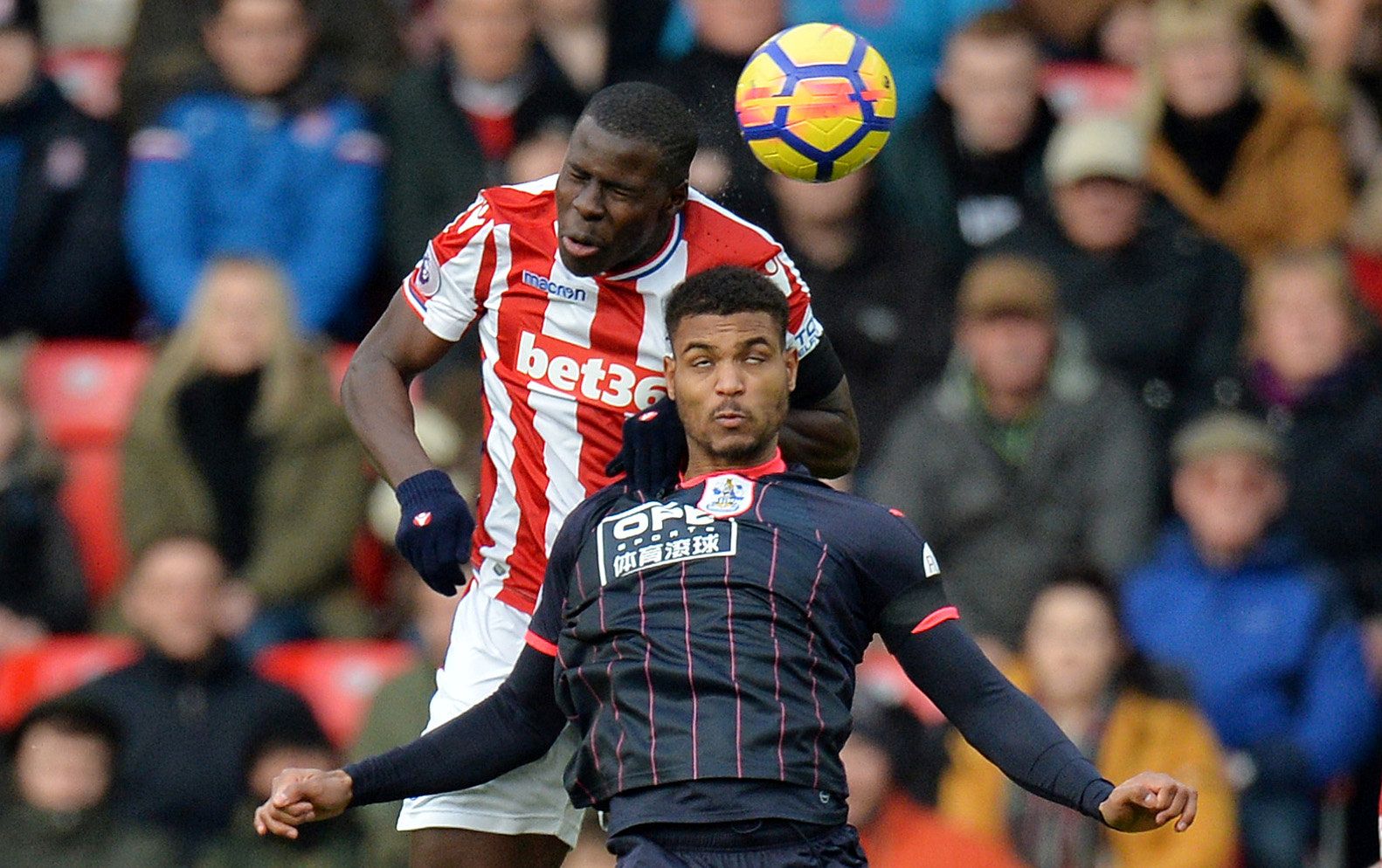 Soccer Football - Premier League - Stoke City vs Huddersfield Town - bet365 Stadium, Stoke-on-Trent, Britain - January 20, 2018   Huddersfield Town’s Steve Mounie in action with Stoke City's Kurt Zouma    REUTERS/Peter Powell    EDITORIAL USE ONLY. No use with unauthorized audio, video, data, fixture lists, club/league logos or "live" services. Online in-match use limited to 75 images, no video emulation. No use in betting, games or single club/league/player publications.  Please contact your ac