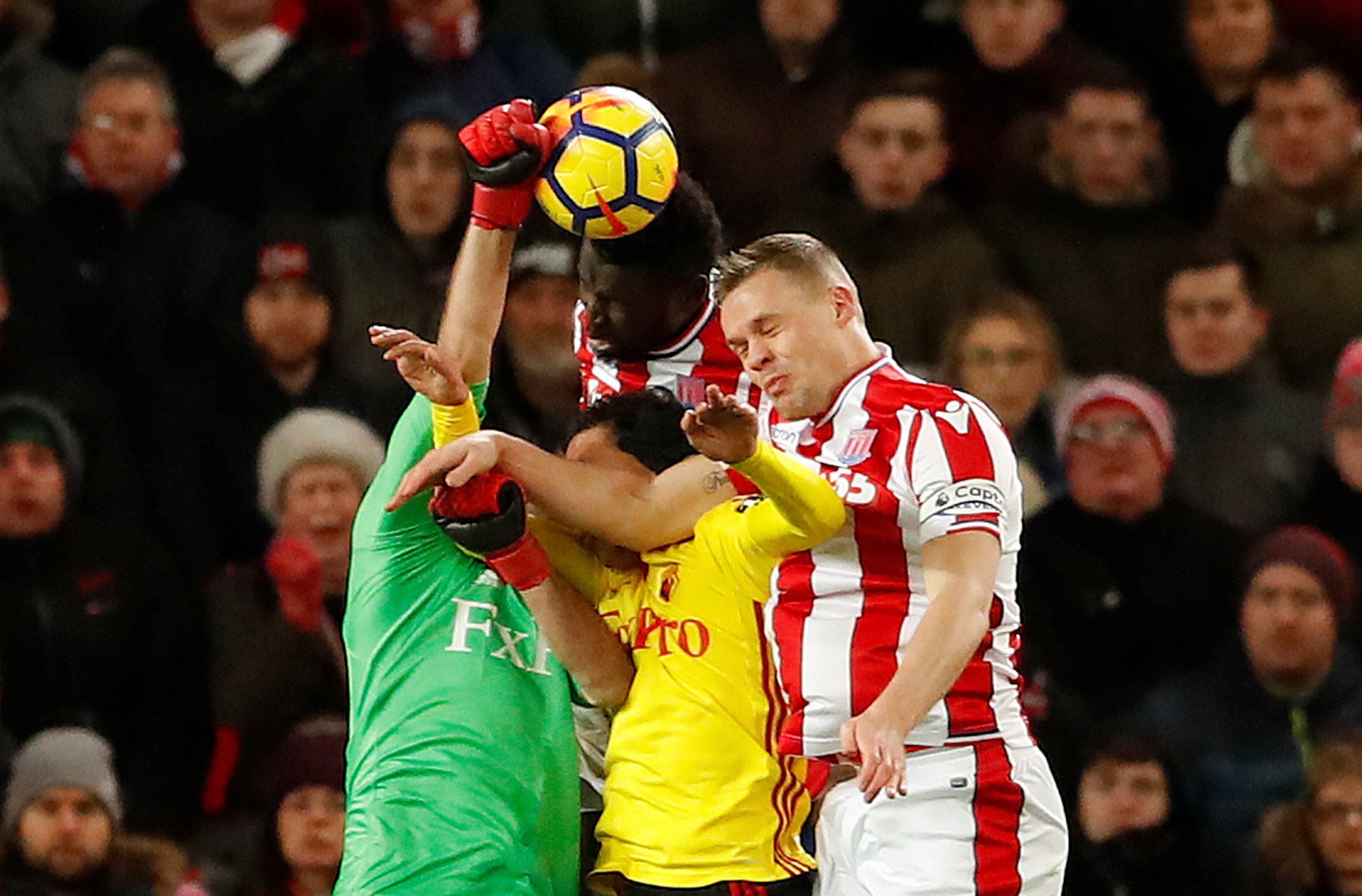 Soccer Football - Premier League - Stoke City vs Watford - bet365 Stadium, Stoke-on-Trent, Britain - January 31, 2018   Watford's Orestis Karnezis in action with Stoke City's Ryan Shawcross            Action Images via Reuters/Andrew Boyers    EDITORIAL USE ONLY. No use with unauthorized audio, video, data, fixture lists, club/league logos or 