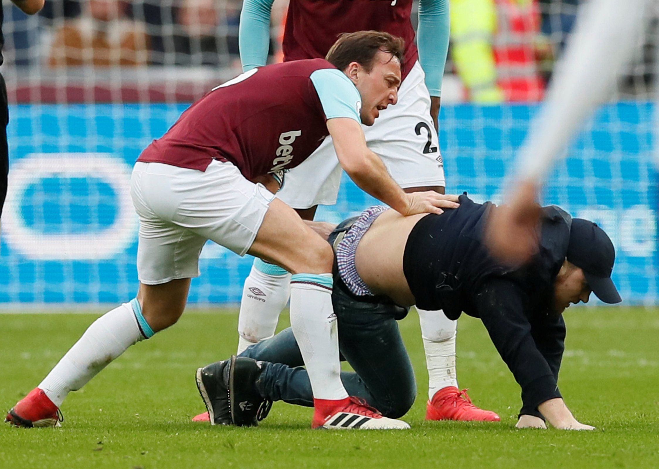 Mark Noble grapes with a fan during West Ham United's Premier League game against Burnley