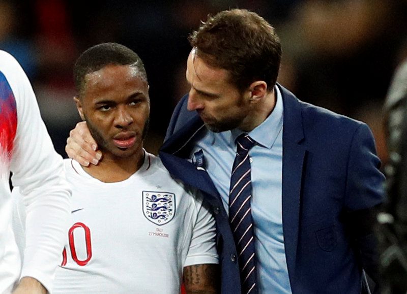 Gareth Southgate discusses with Raheem Sterling