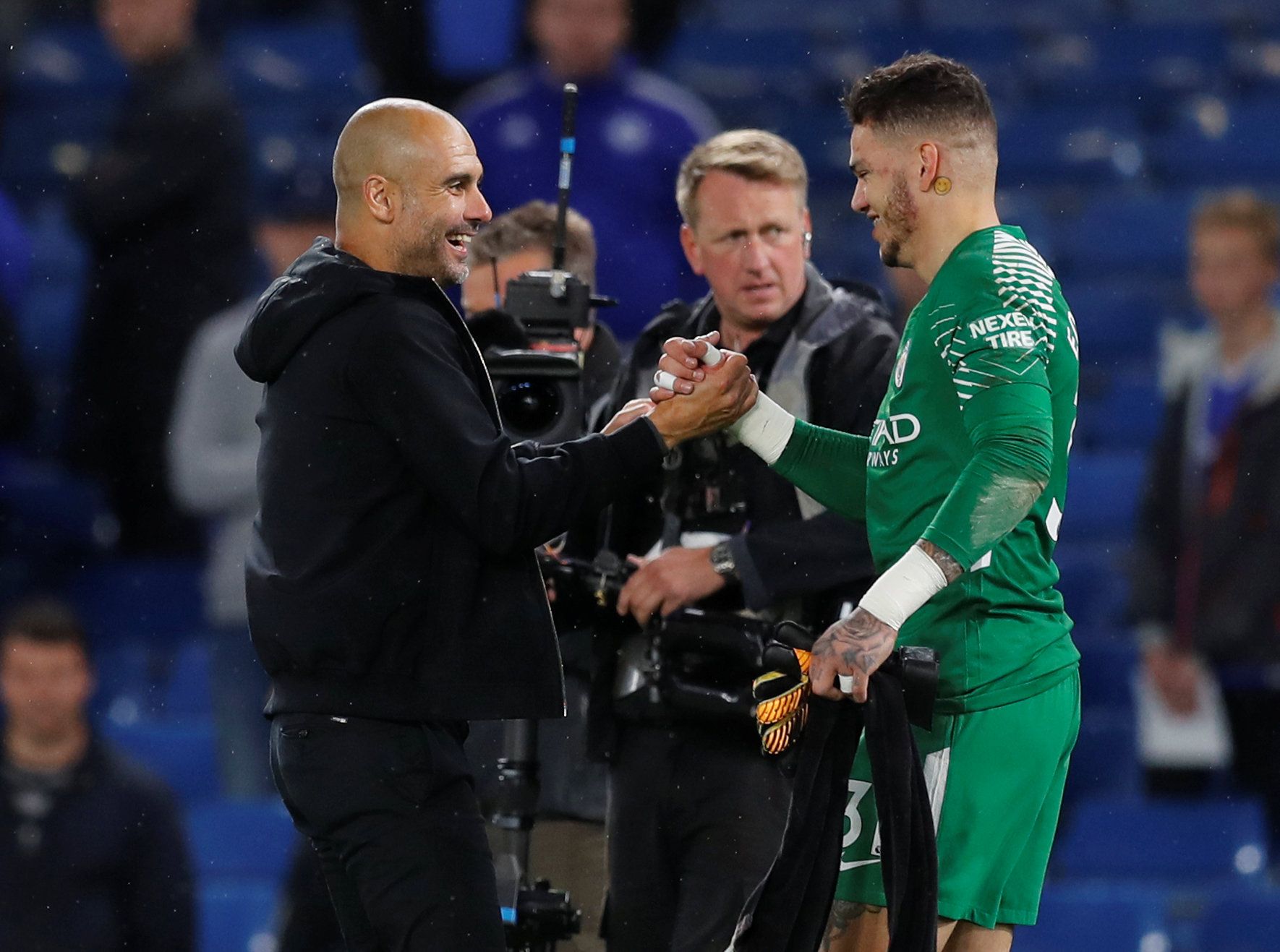 Pep Guardiola and Ederson embrace after the final whistle