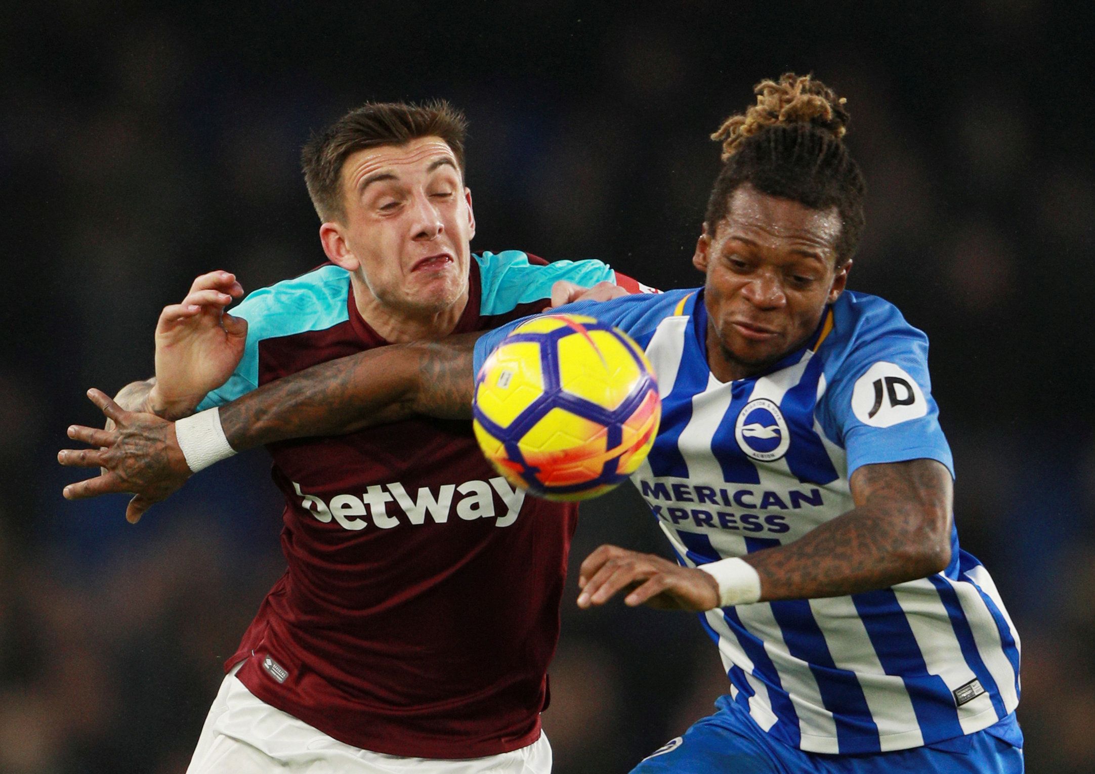 Soccer Football - Premier League - Brighton &amp; Hove Albion vs West Ham United - The American Express Community Stadium, Brighton, Britain - February 3, 2018   West Ham United's Jordan Hugill in action with Brighton's Gaetan Bong    REUTERS/Ian Walton    EDITORIAL USE ONLY. No use with unauthorized audio, video, data, fixture lists, club/league logos or 
