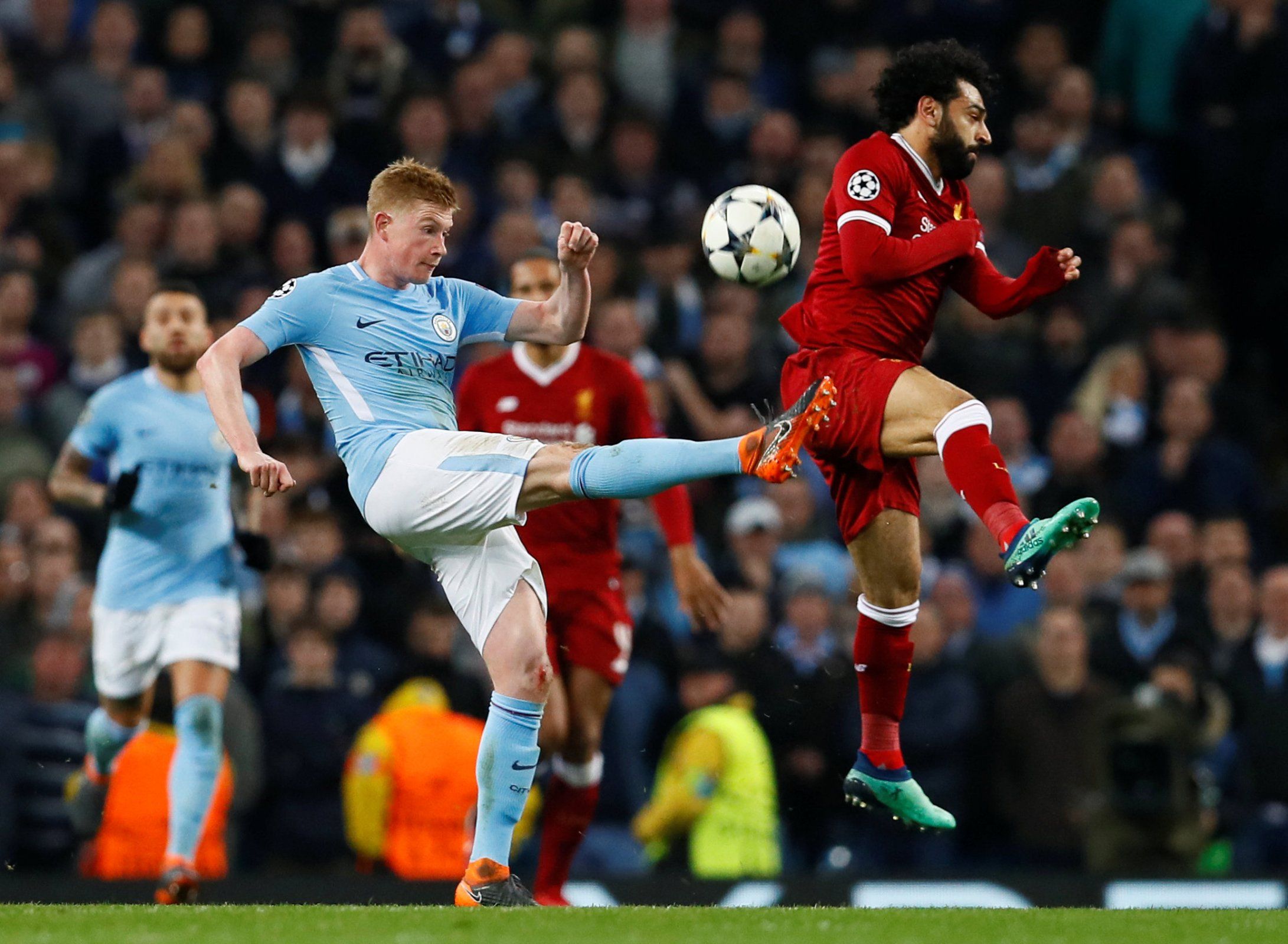 Kevin De Bruyne and Mohamed Salah fight for the ball in the Champions League quarter-final between Manchester City and Liverpool