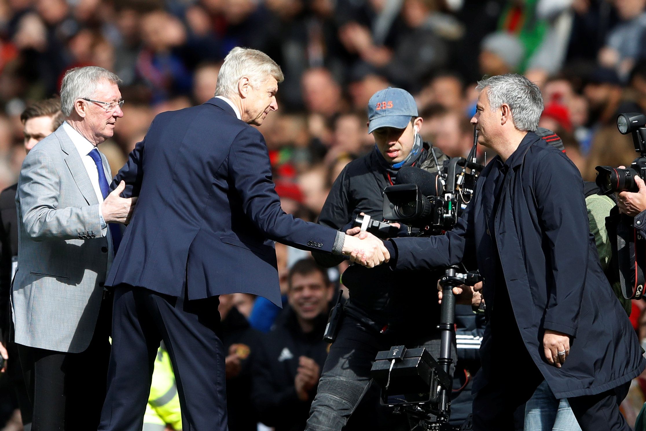 Sir Alex Ferguson presents Arsene Wenger with a gift at Old Trafford