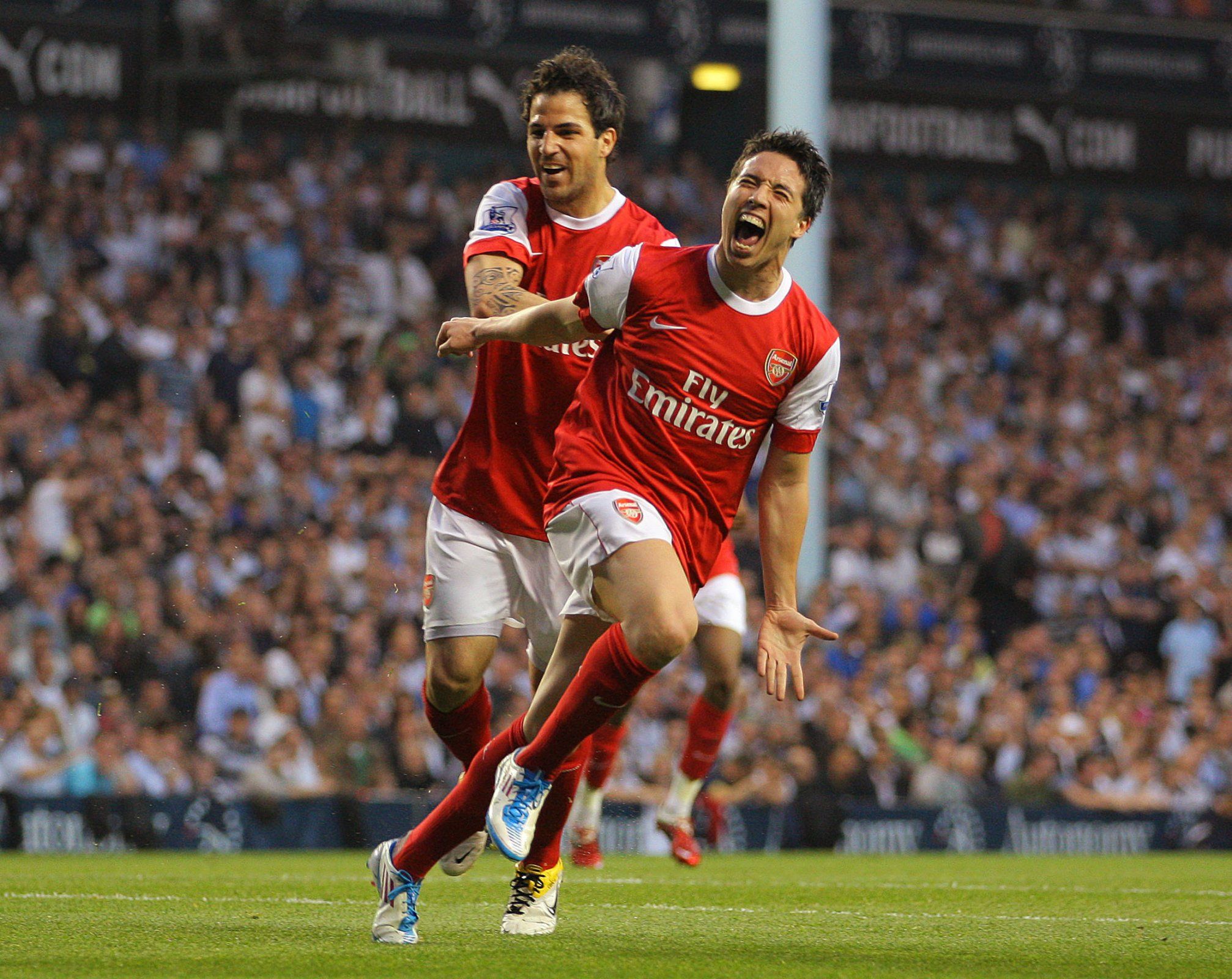 Cesc Fabregas and Samir Nasri celebrate scoring for Arsenal