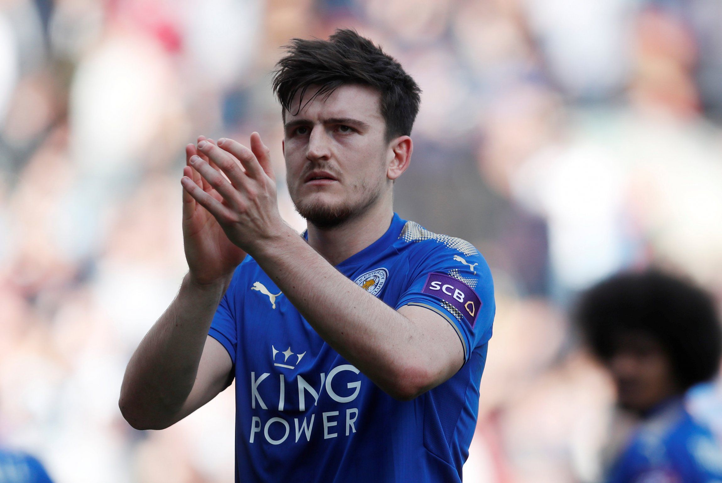 Leicester City defender Harry Maguire applauds supporters