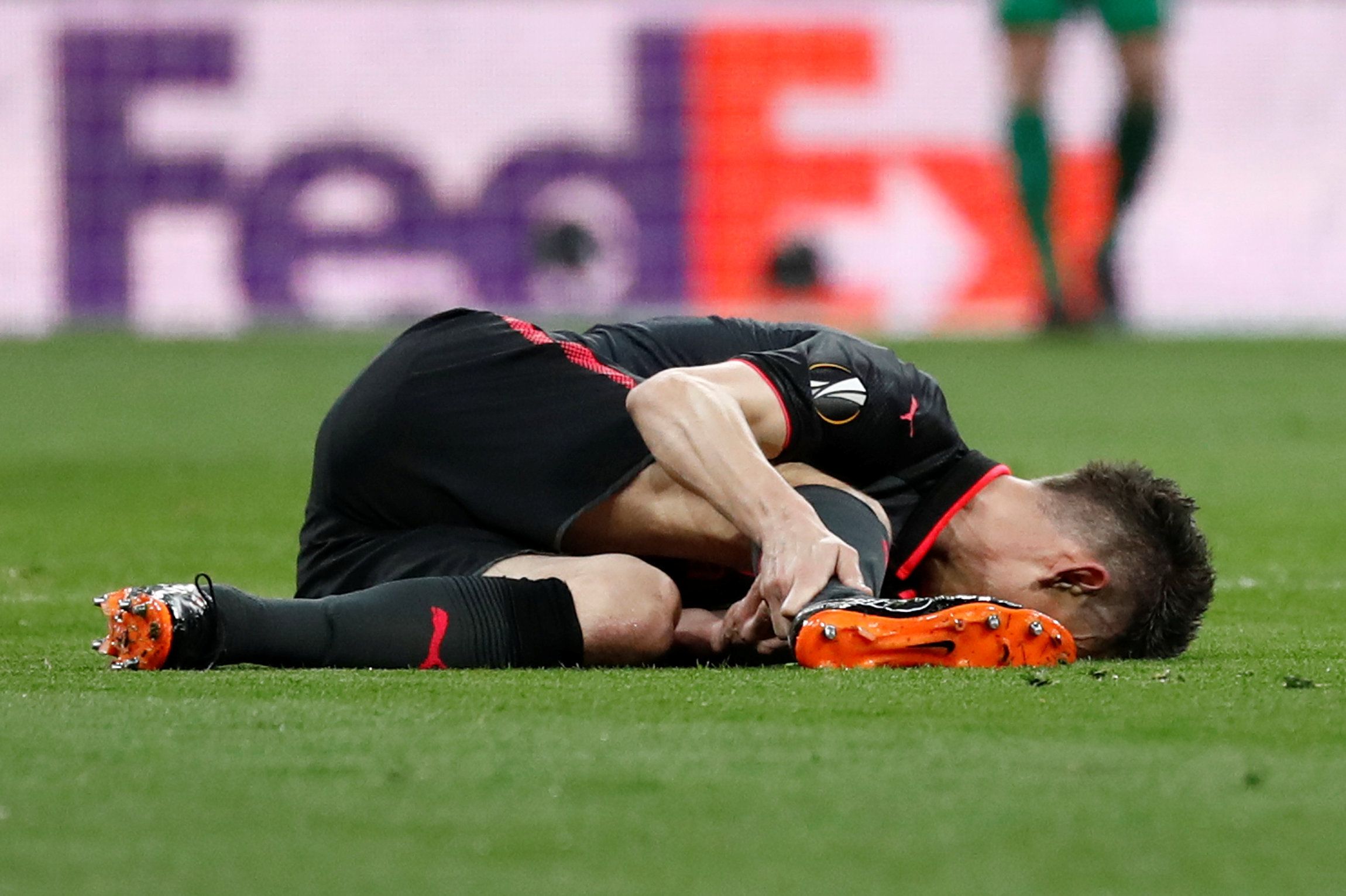 Laurent Koscielny suffers an injury during Arsenal's Europa League match against Atletico Madrid