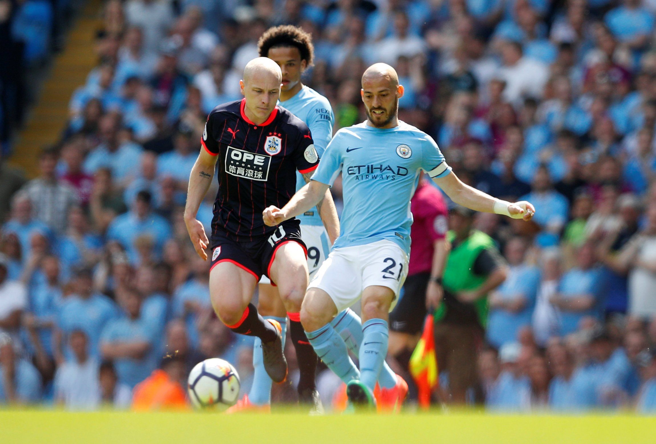 Aaron Mooy in action with David Silva