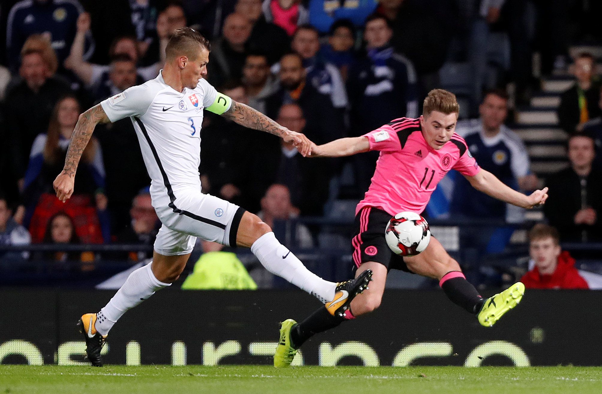 Soccer Football - 2018 World Cup Qualifications - Europe - Scotland vs Slovakia - Hampden Park, Glasgow, Britain - October 5, 2017  Slovakia’s Martin Skrtel  in action with Scotland’s James Forrest    REUTERS/Russell Cheyne