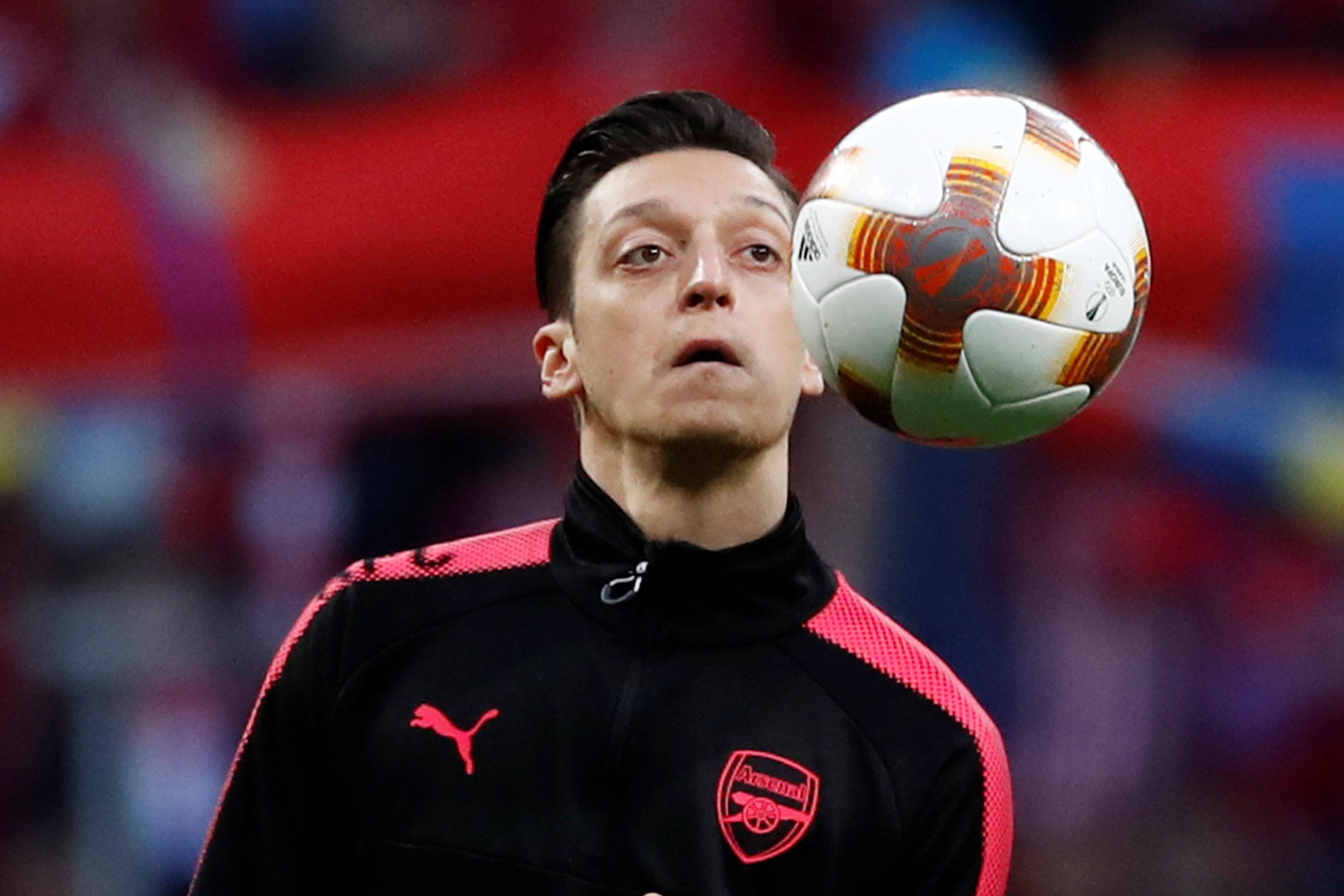 Mesut Ozil looks at the ball in training