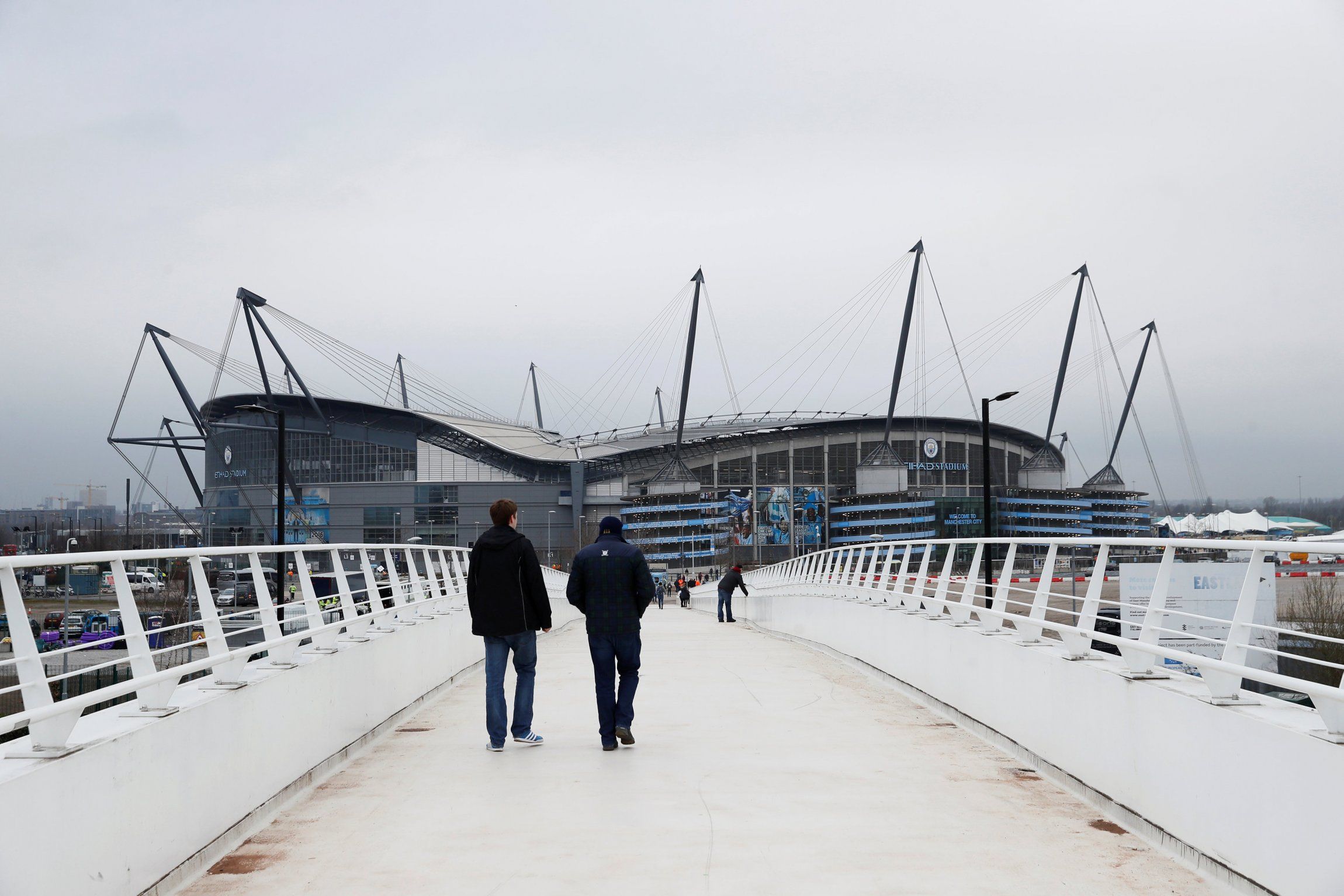 Fans arrive at the Etihad Stadium before a Man City game