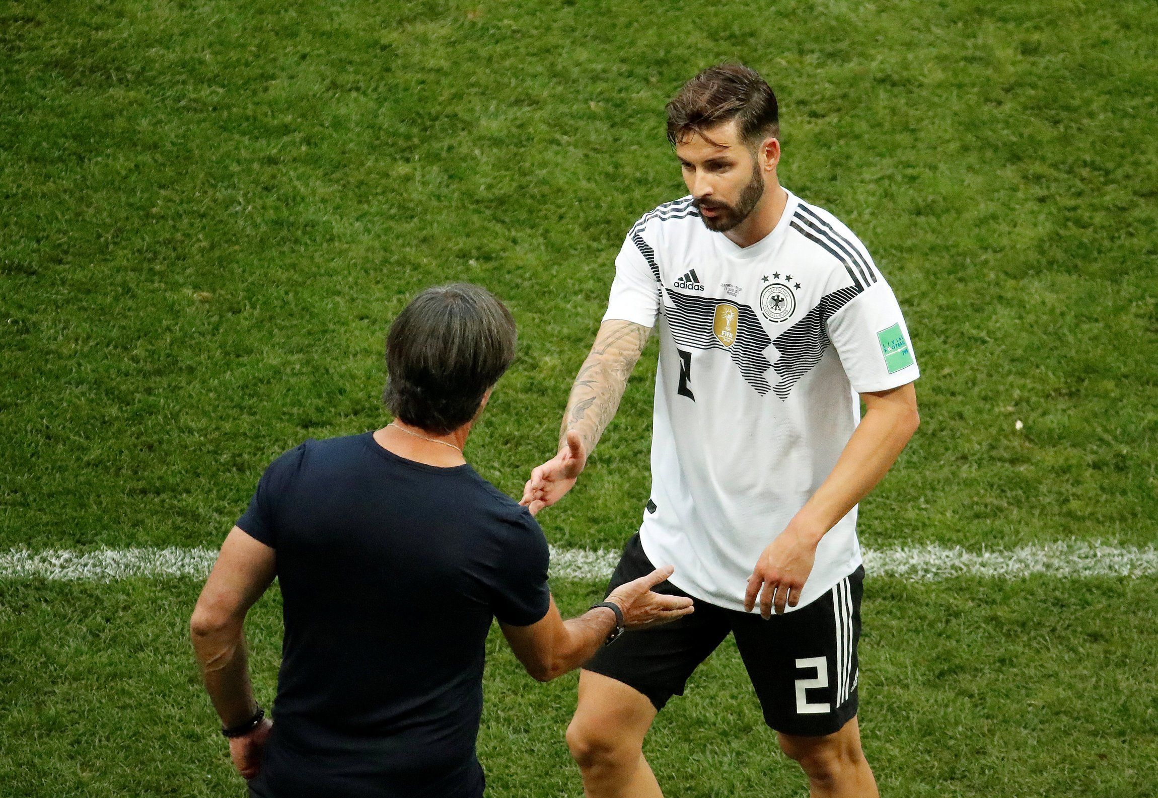 Germany's Marvin Plattenhardt shakes hands with coach Joachim Low after being substituted