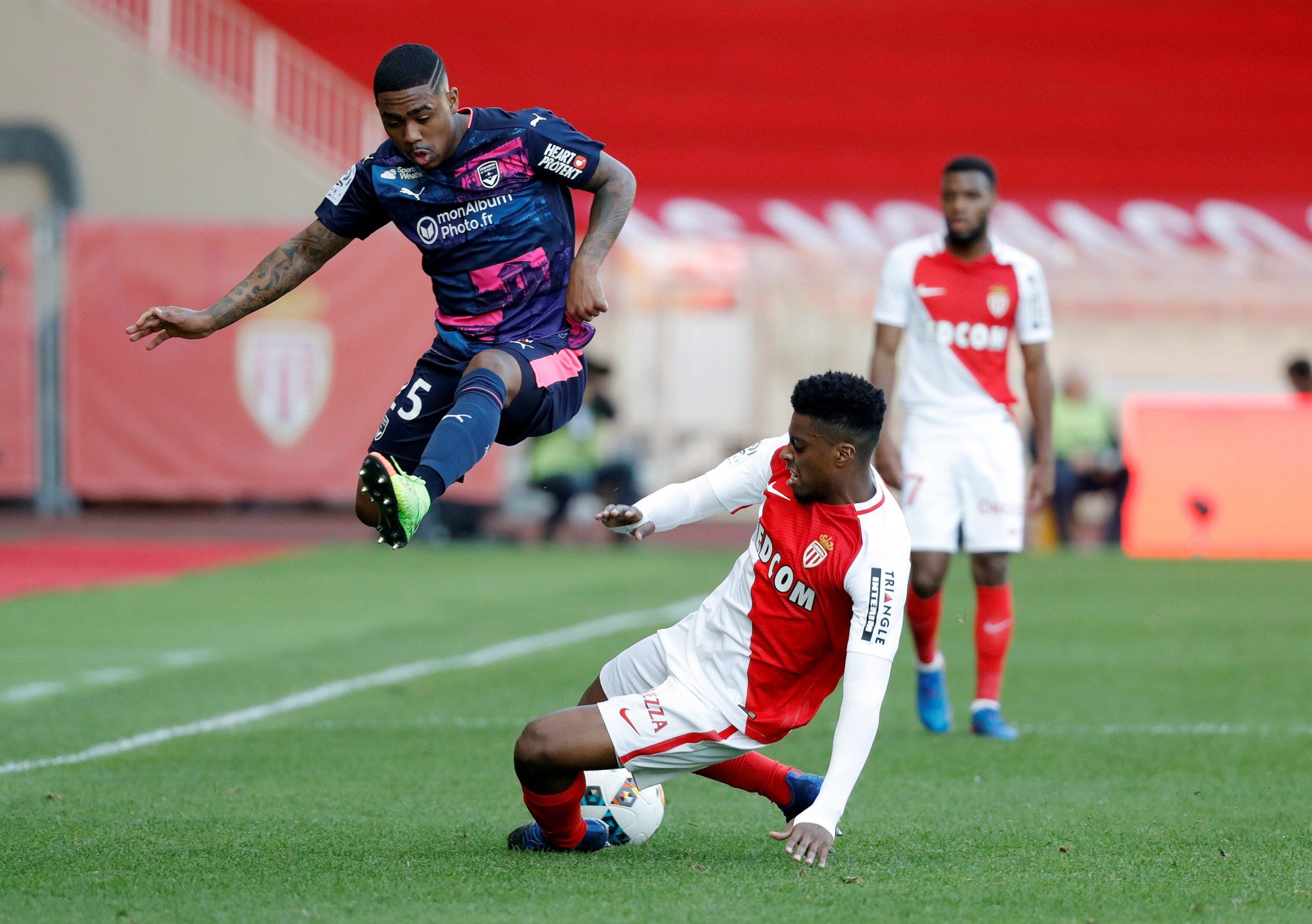 Malcom leaps in the air to avoid a tackle in Bordeaux's clash against Monaco
