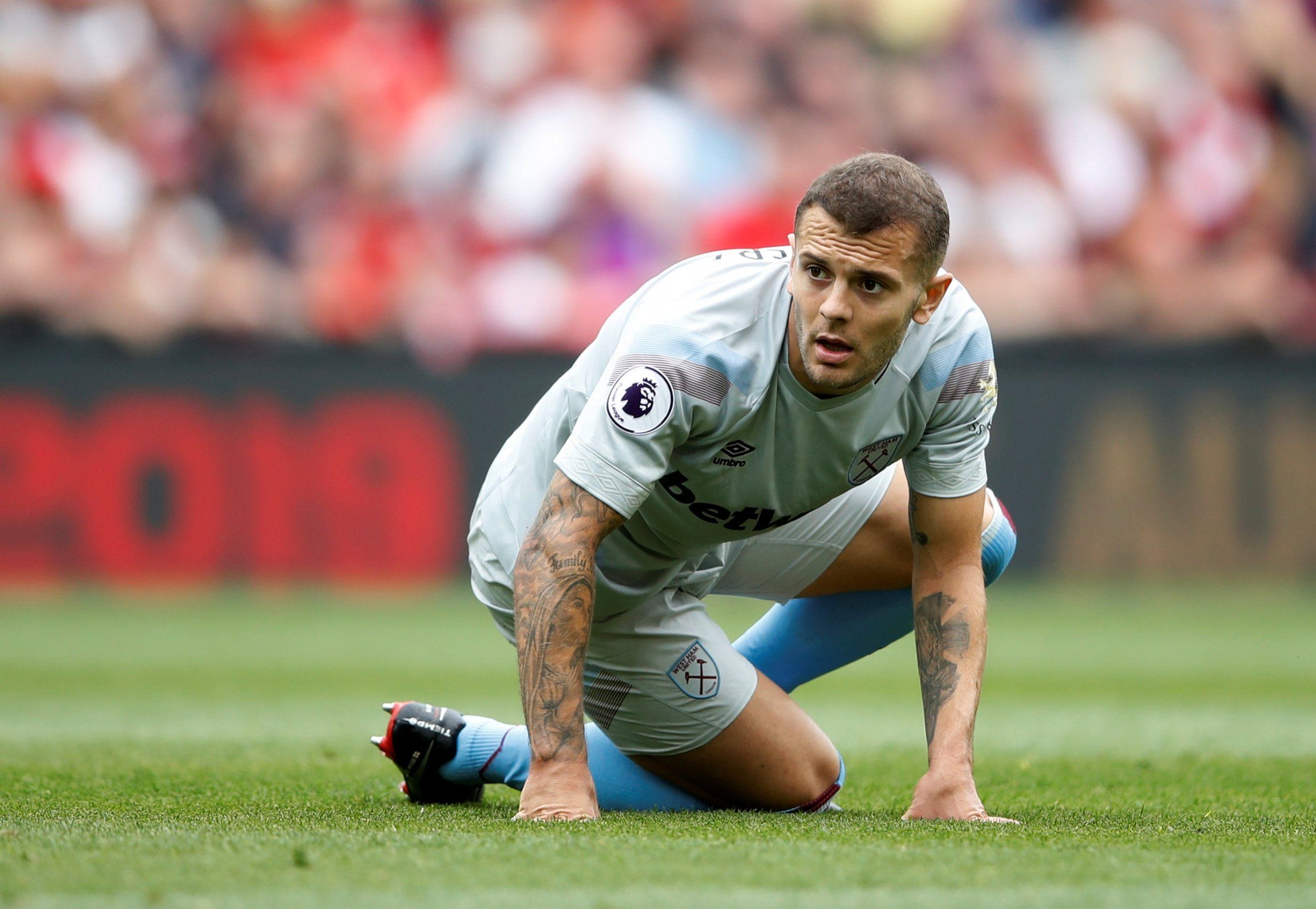 Jack Wilshere rises to his feet during West Ham United v Liverpool