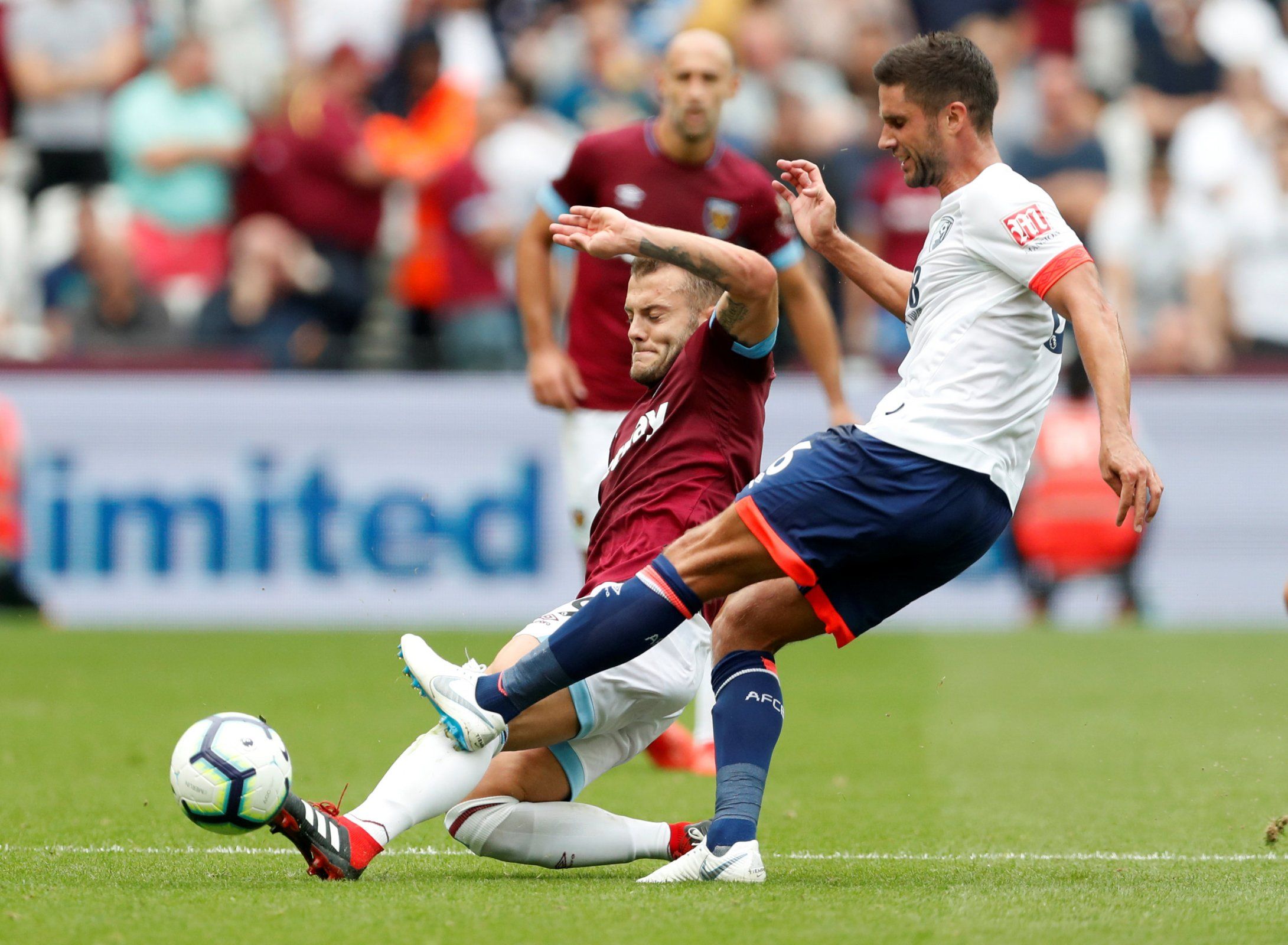 Jack Wilshere tackles Bournemouth's Andrew Surman
