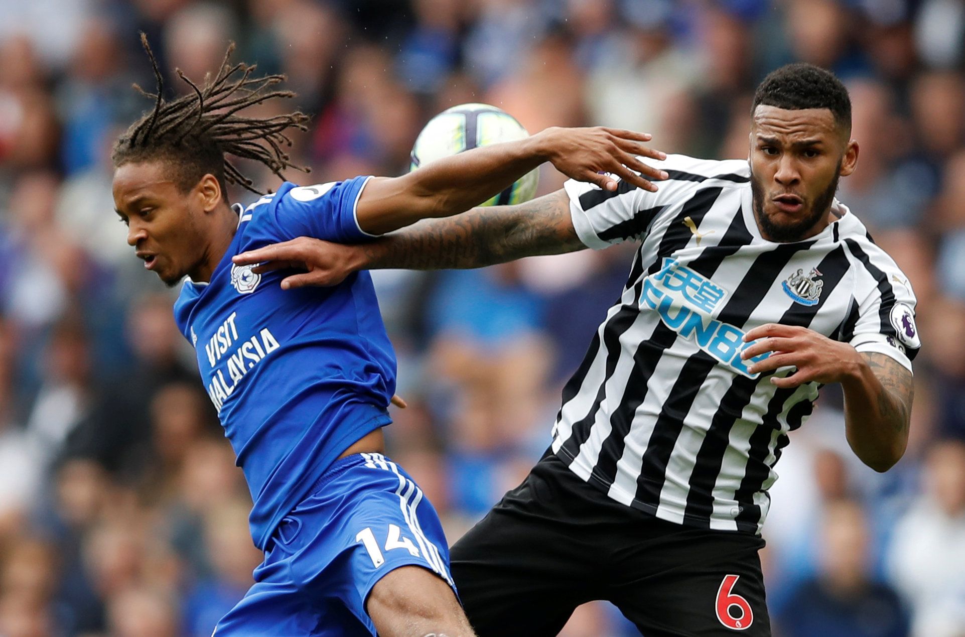 Soccer Football - Premier League - Cardiff City v Newcastle United- Cardiff City Stadium, Cardiff, Britain - August 18, 2018   Cardiff City's Bobby Reid and Newcastle United's Jamaal Lascelles      Action Images via Reuters/Carl Recine    EDITORIAL USE ONLY. No use with unauthorized audio, video, data, fixture lists, club/league logos or "live" services. Online in-match use limited to 75 images, no video emulation. No use in betting, games or single club/league/player publications.  Please conta