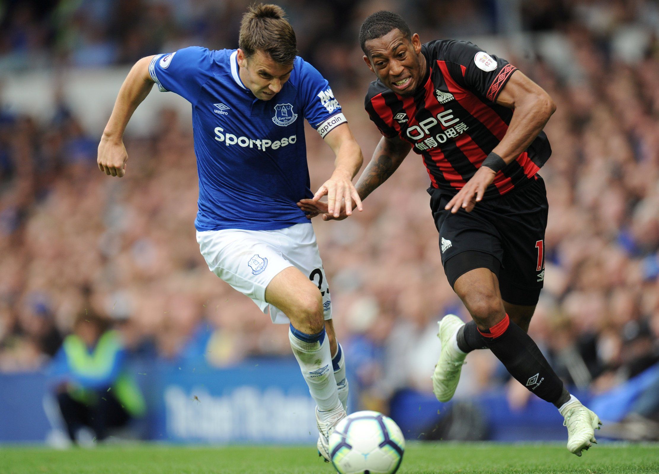 Everton captain Seamus Coleman chases Huddersfield's Rajiv van La Parra