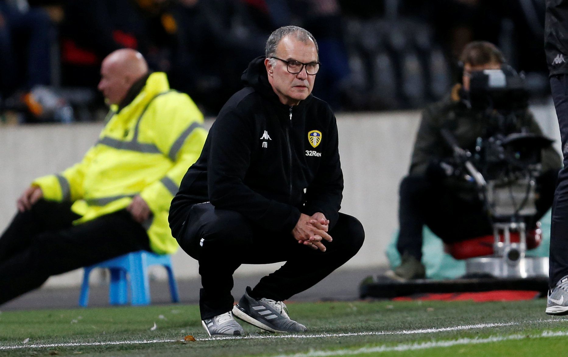 Leeds United manager Marcelo Bielsa crouches down during win against Hull