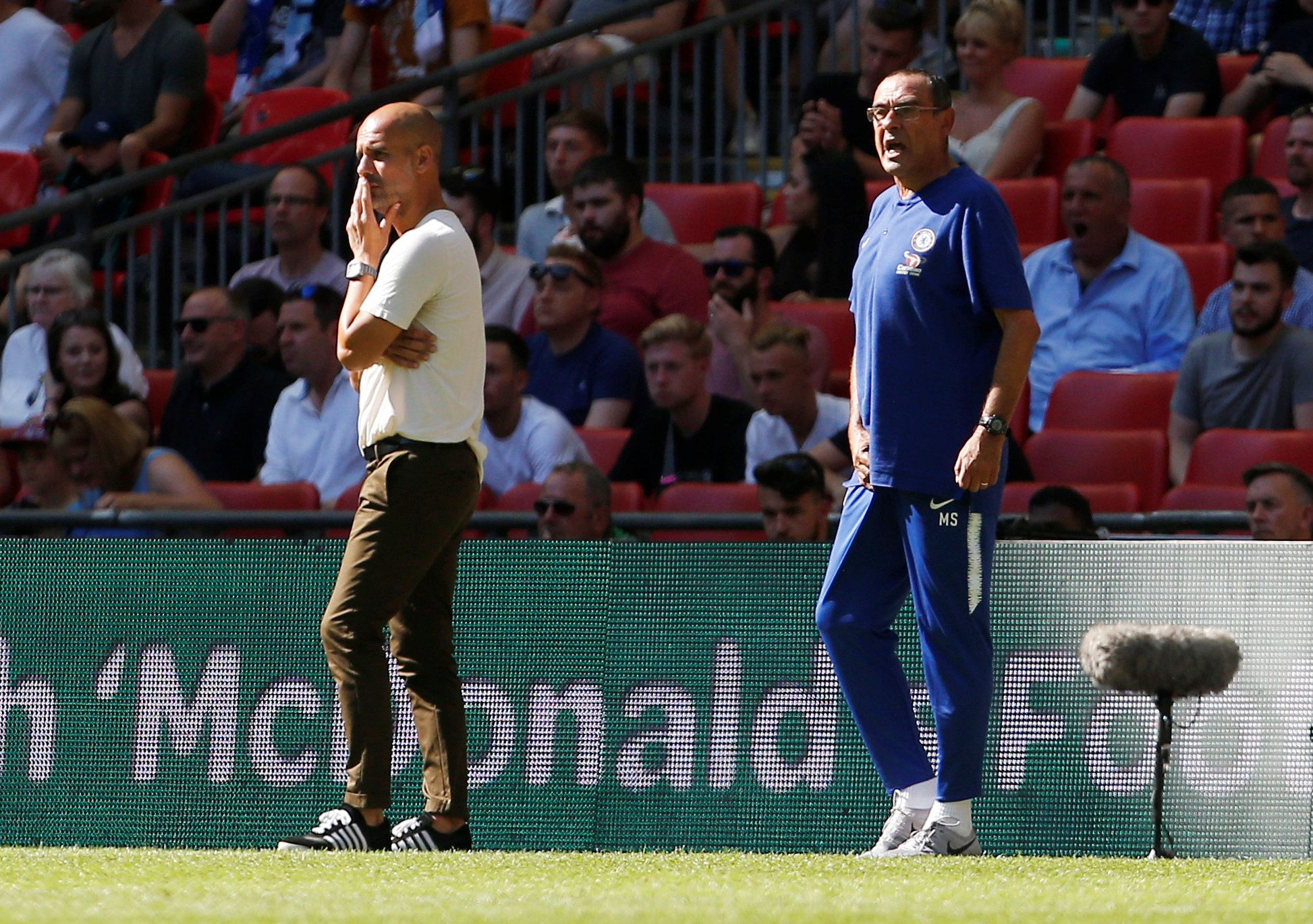 Chelsea manager Maurizio Sarri reacts as Manchester City manager Pep Guardiola looks on
