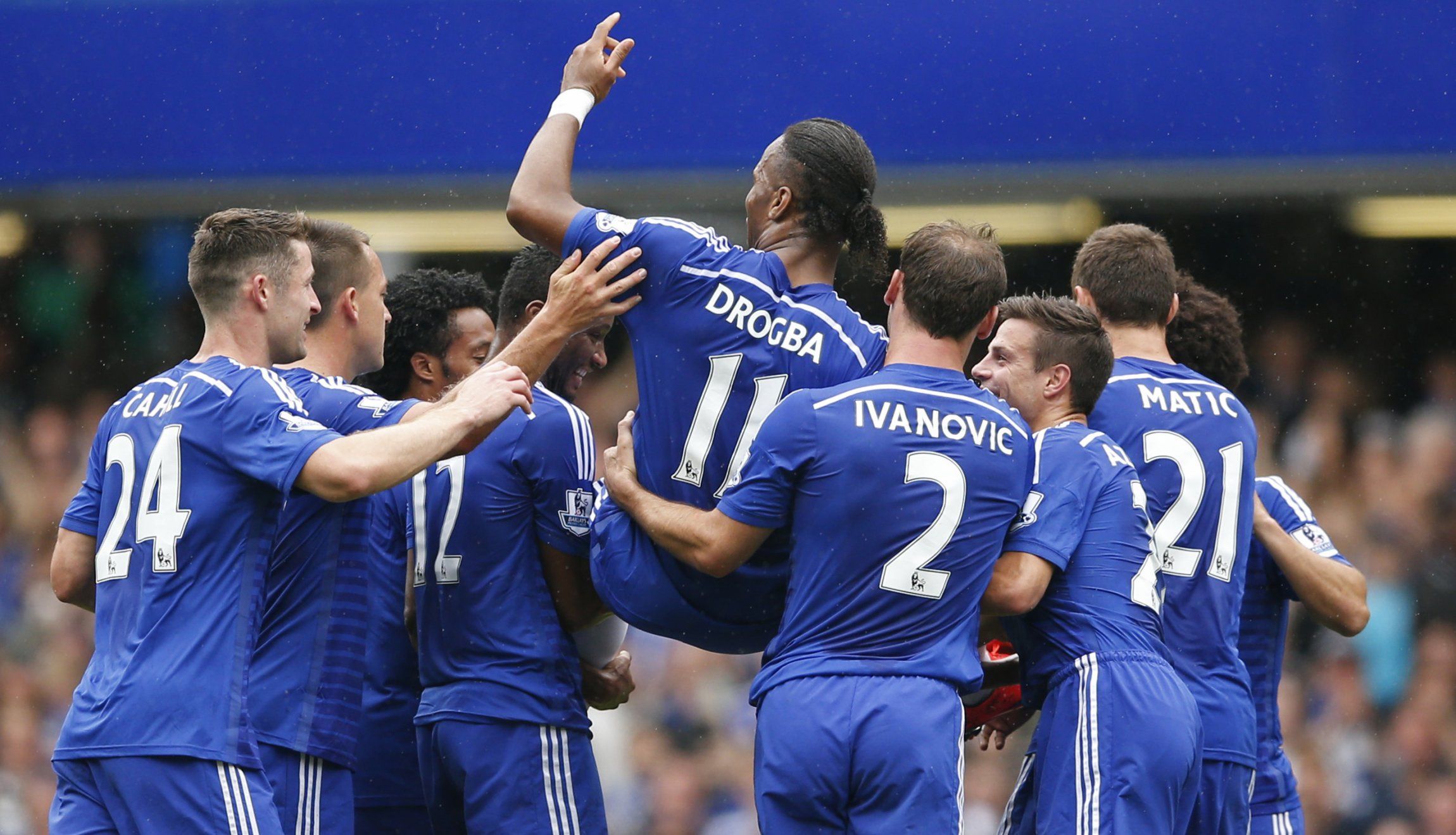 Chelsea's players carry Didier Drogba off the pitch