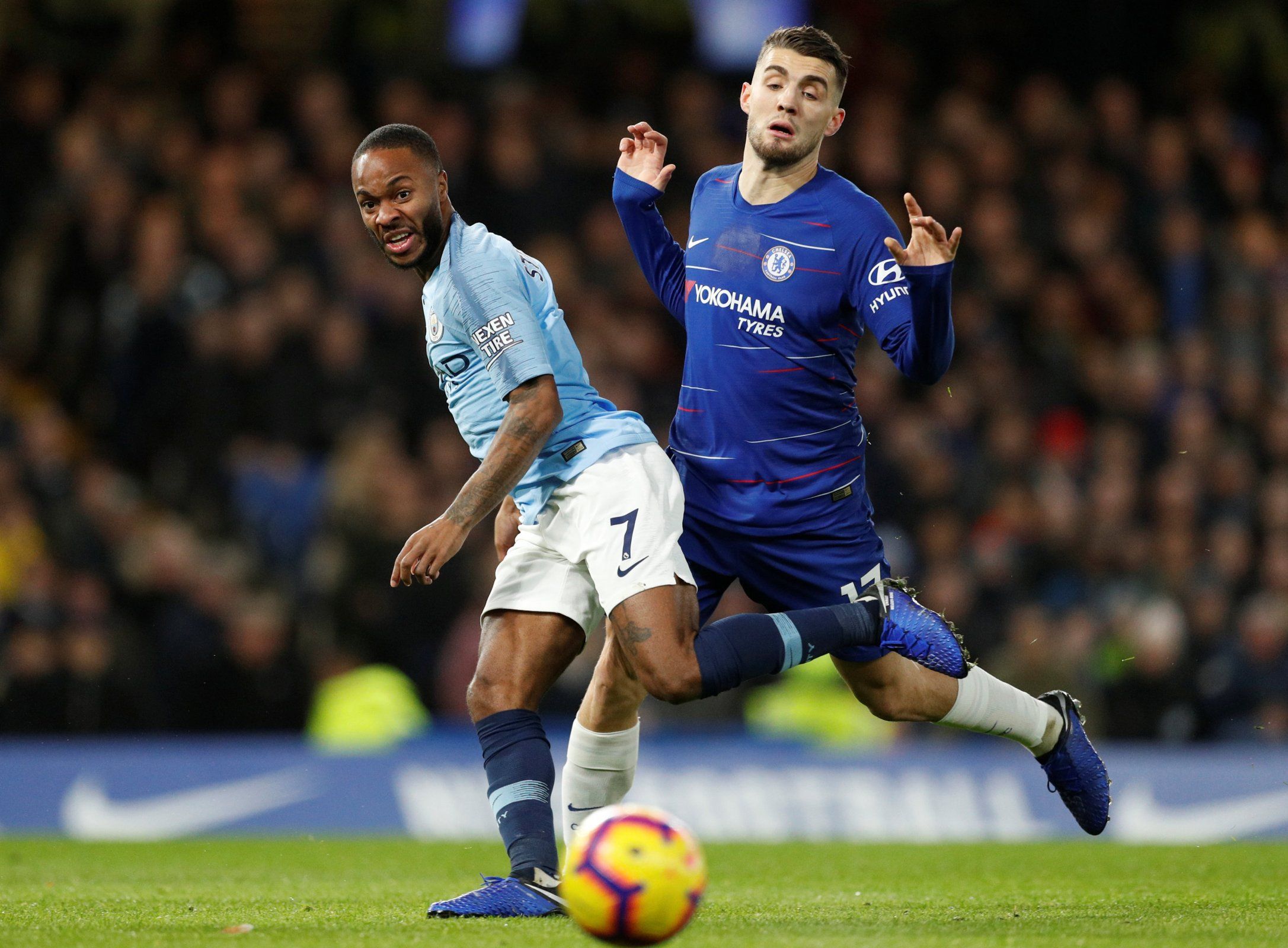Raheem Sterling and Mateo Kovacic focus on the ball