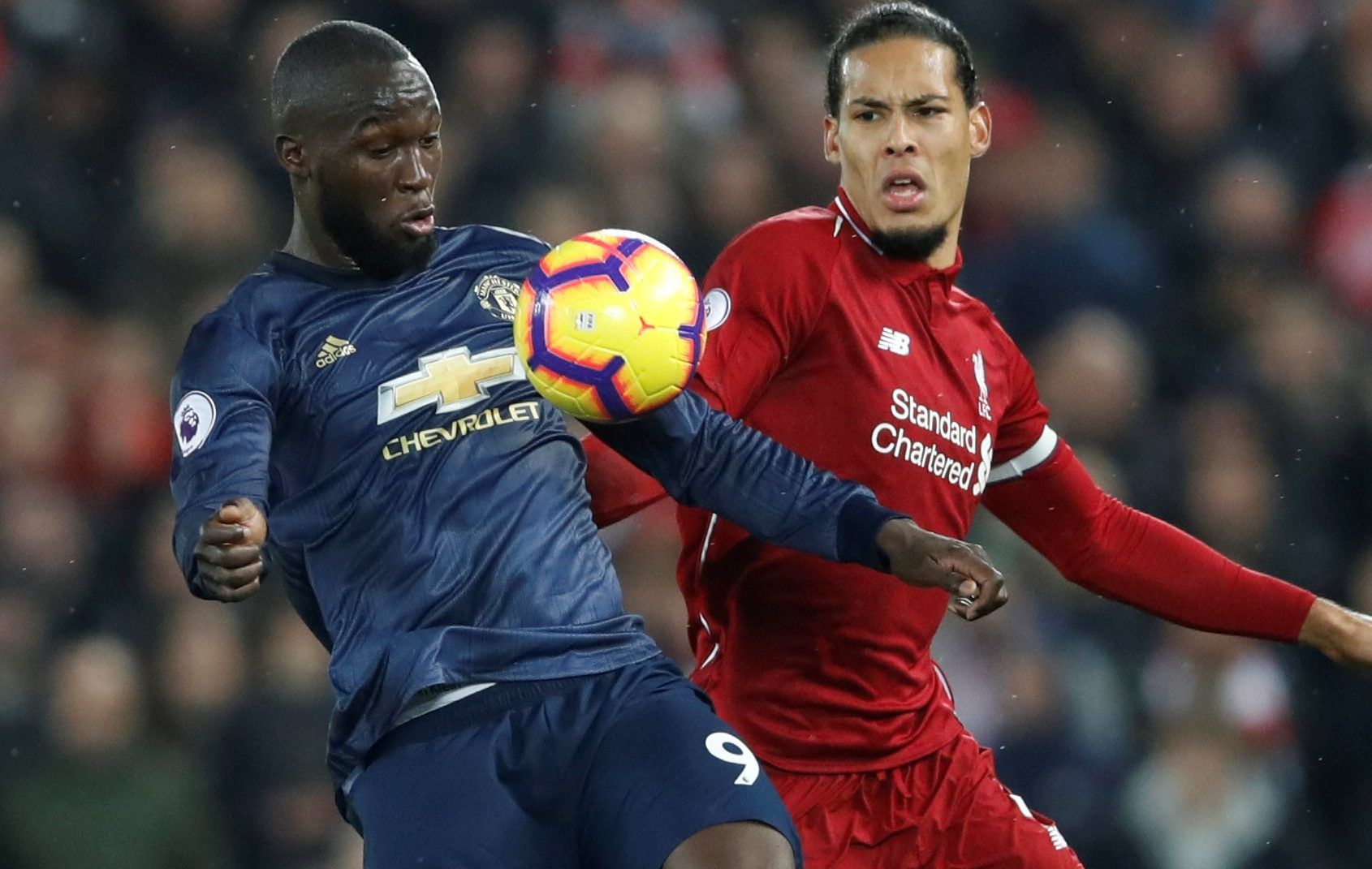 Soccer Football - Premier League - Liverpool v Manchester United - Anfield, Liverpool, Britain - December 16, 2018  Liverpool's Virgil van Dijk in action with Manchester United's Romelu Lukaku   Action Images via Reuters/Carl Recine  EDITORIAL USE ONLY. No use with unauthorized audio, video, data, fixture lists, club/league logos or 