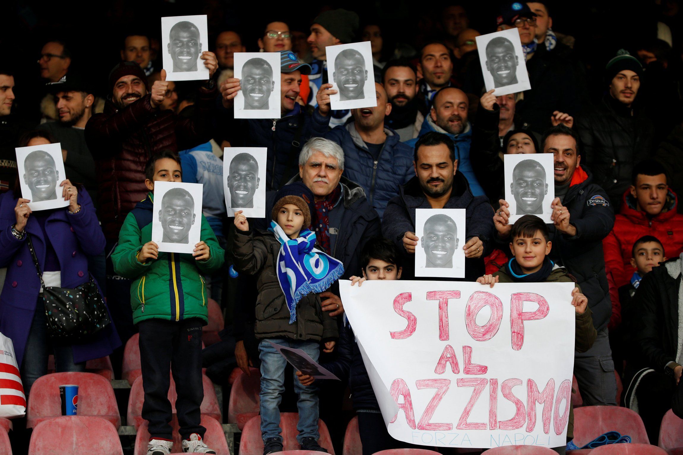 Napoli fans hold up pictures of Kalidou Koulibaly inside the stadium before the Bologna match