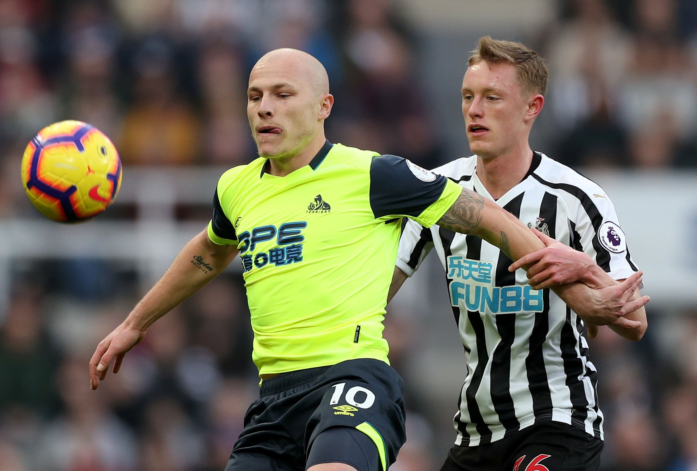 Soccer Football - Premier League - Newcastle United v Huddersfield Town - St James' Park, Newcastle, Britain - February 23, 2019  Huddersfield Town's Aaron Mooy in action with Newcastle United's Sean Longstaff    Action Images via Reuters/Lee Smith  EDITORIAL USE ONLY. No use with unauthorized audio, video, data, fixture lists, club/league logos or 