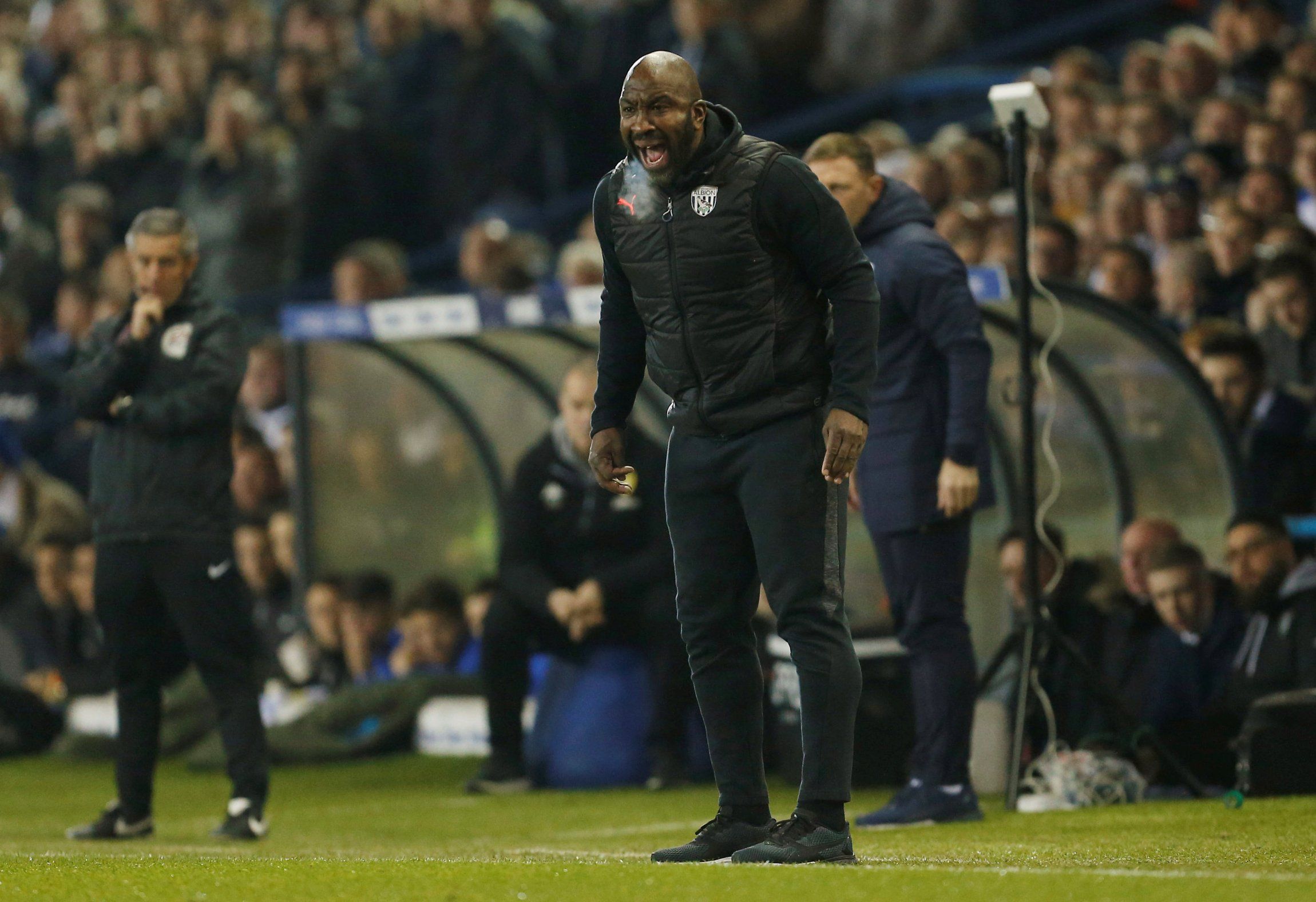 Darren Moore shouts instructions at his players during his time with West Brom.