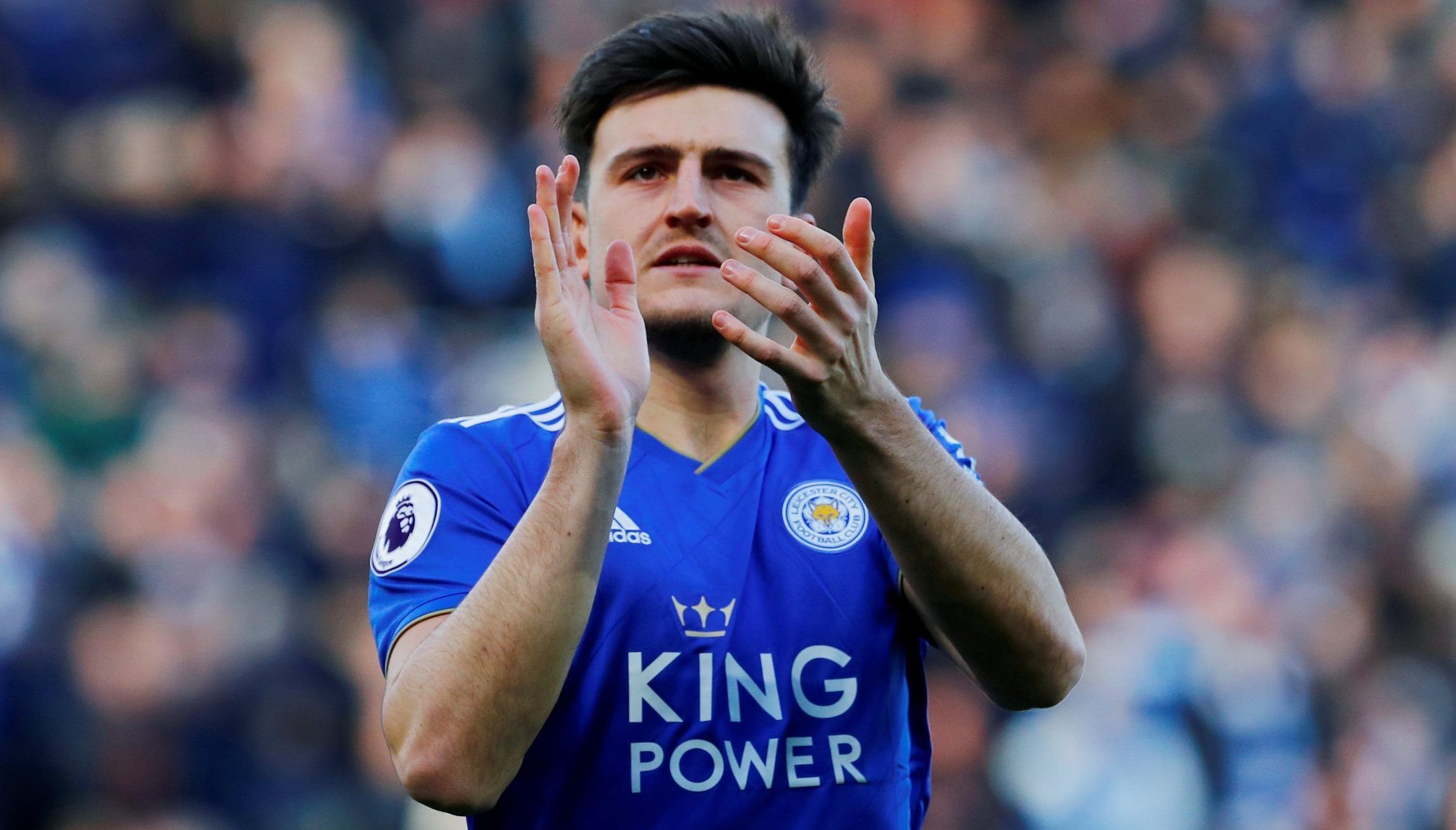Harry Maguire applauds the fans. 