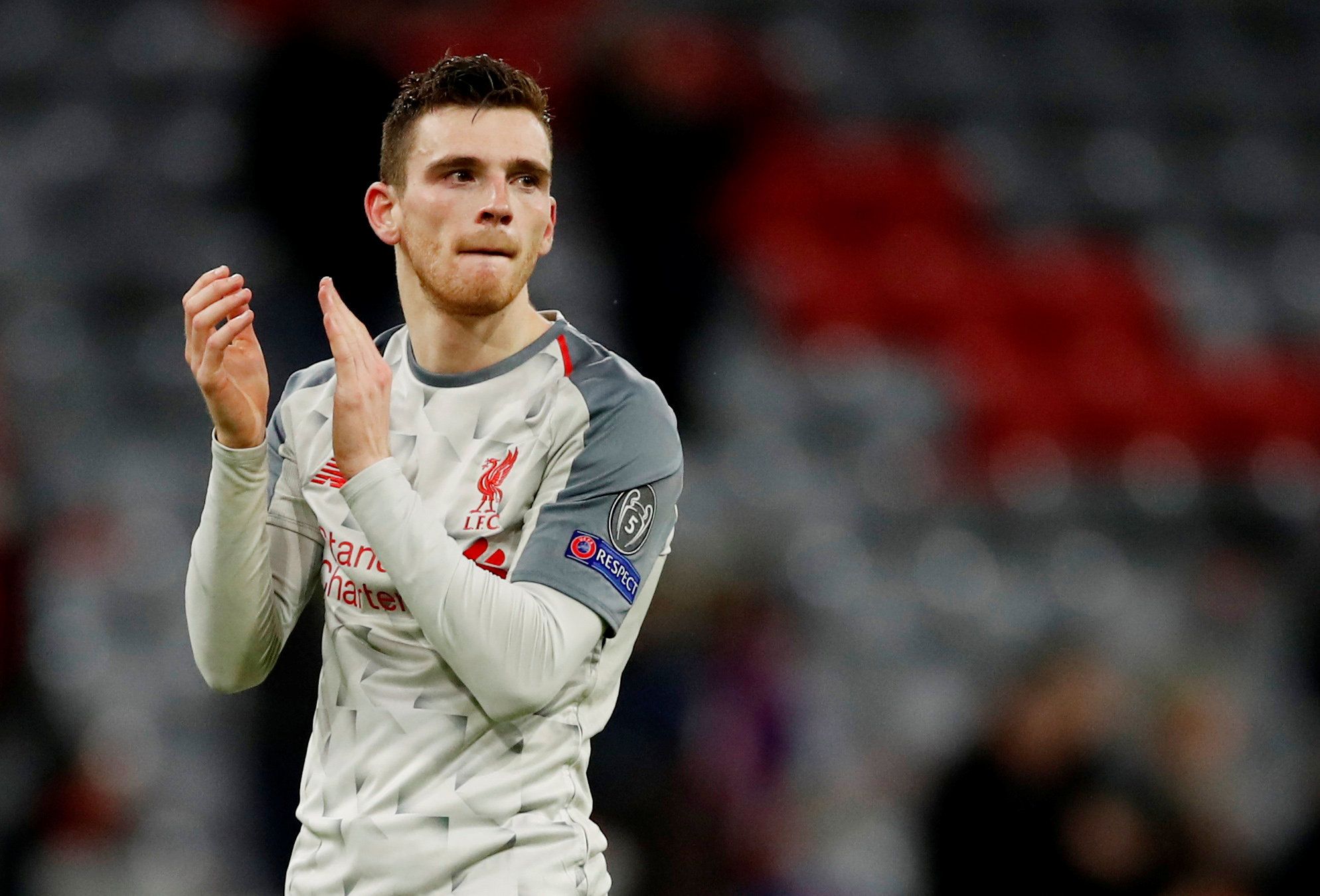 Soccer Football - Champions League - Round of 16 Second Leg - Bayern Munich v Liverpool - Allianz Arena, Munich, Germany - March 13, 2019  Liverpool's Andrew Robertson applauds the fans after the match  Action Images via Reuters/Andrew Boyers