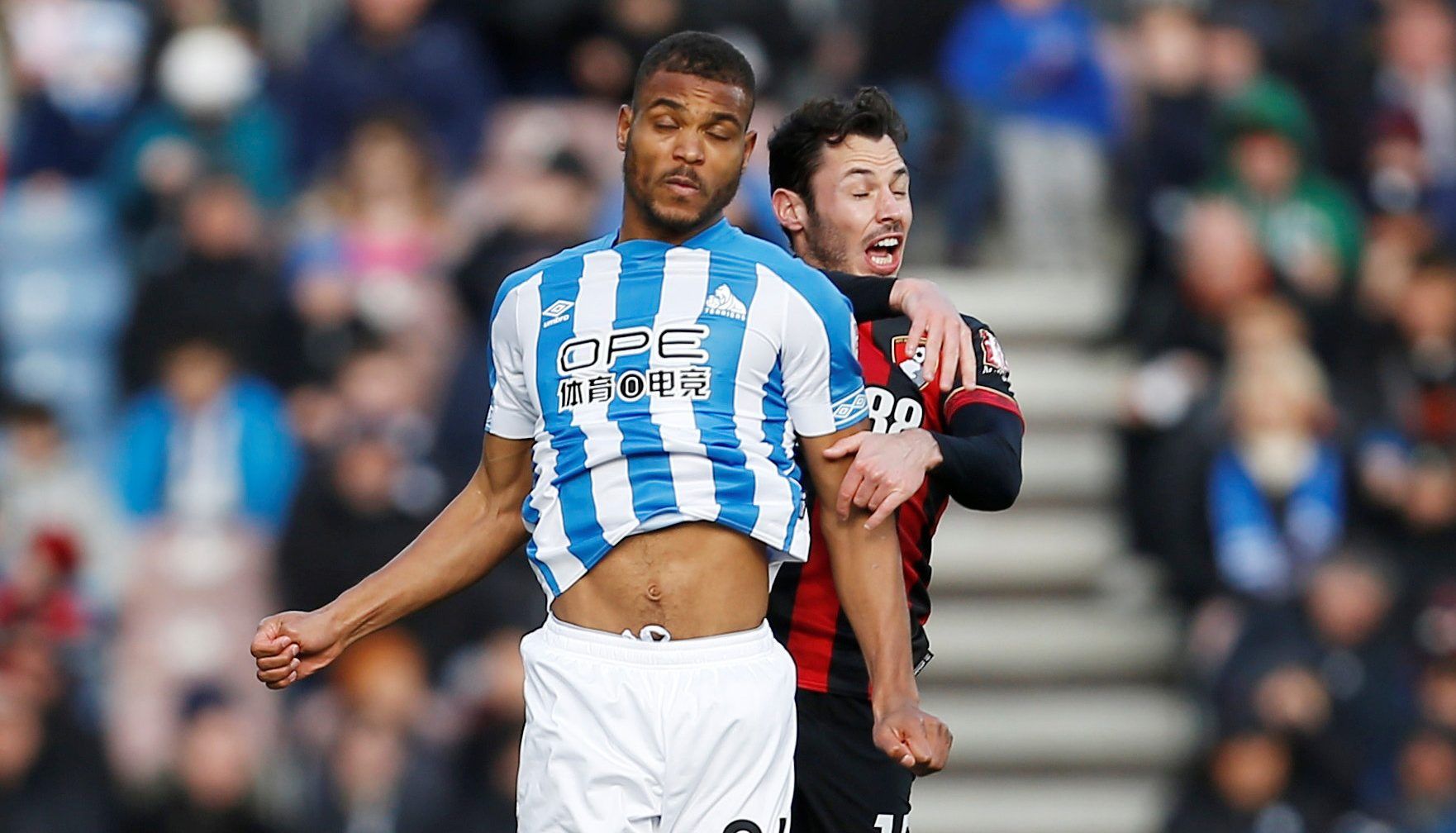Soccer Football - Premier League - Huddersfield Town v AFC Bournemouth - John Smith's Stadium, Huddersfield, Britain - March 9, 2019  Huddersfield Town's Steve Mounie in action with Bournemouth's Adam Smith      Action Images via Reuters/Craig Brough  EDITORIAL USE ONLY. No use with unauthorized audio, video, data, fixture lists, club/league logos or 