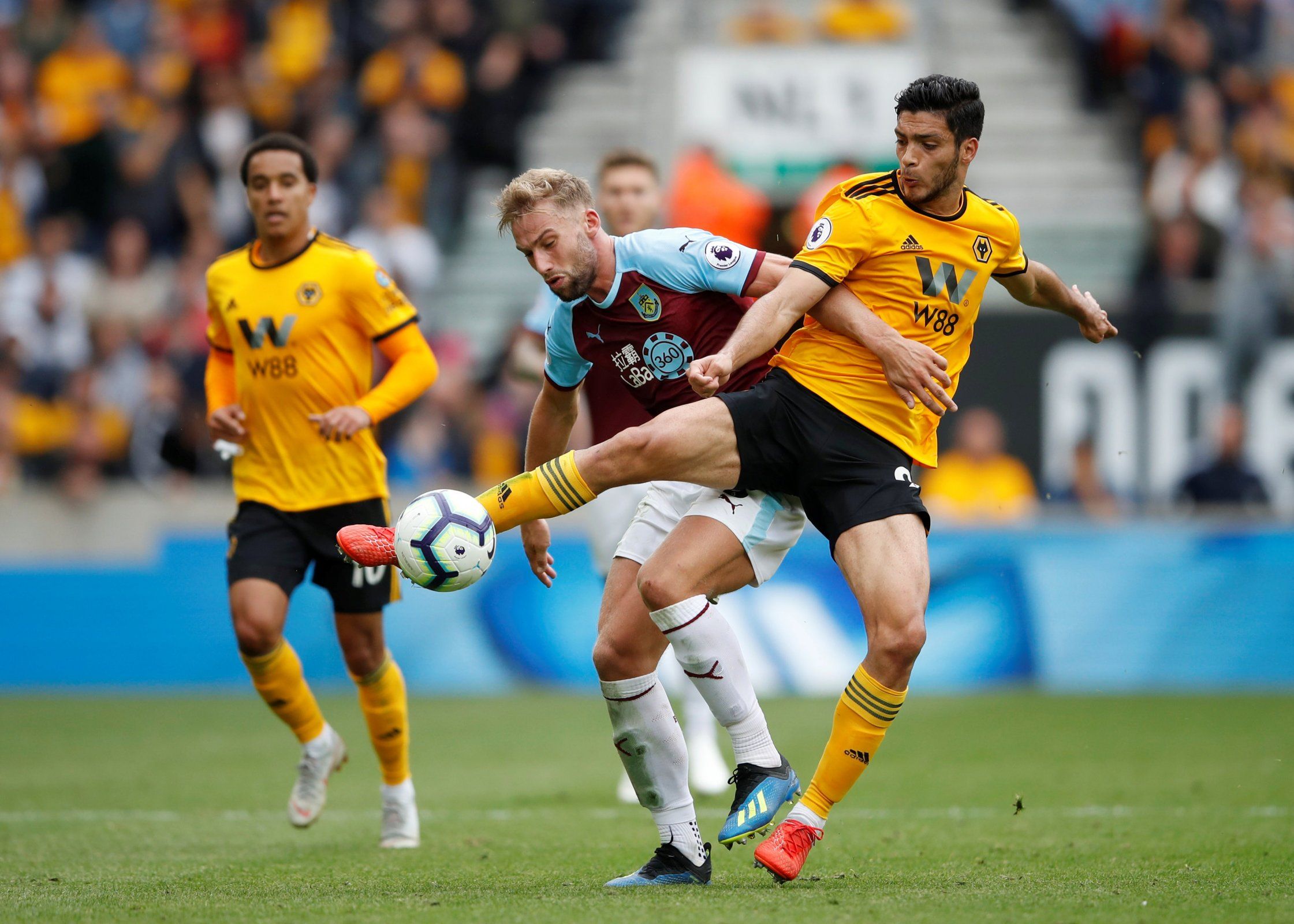 Raul Jimenez and Ben Mee battle for the ball. 
