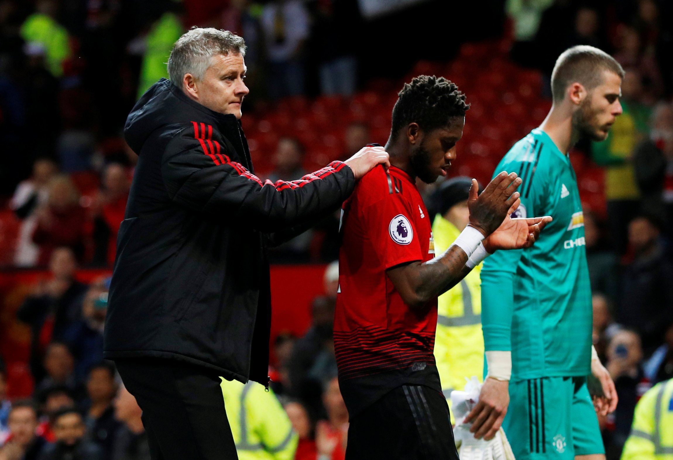 Manchester United manager Ole Gunnar Solskjaer consoles midfielder Fred after Manchester City defeat