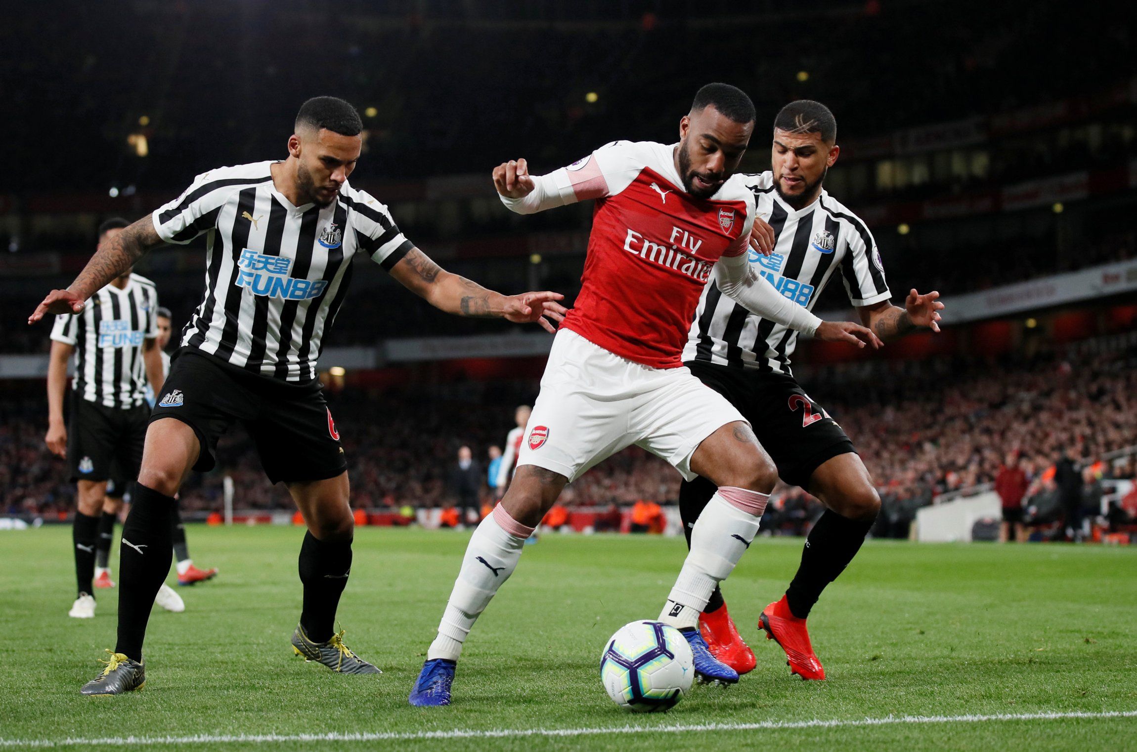 Newcastle defender DeAndre Yedlin battles with Arsenal striker Pierre-Emerick Aubameyang