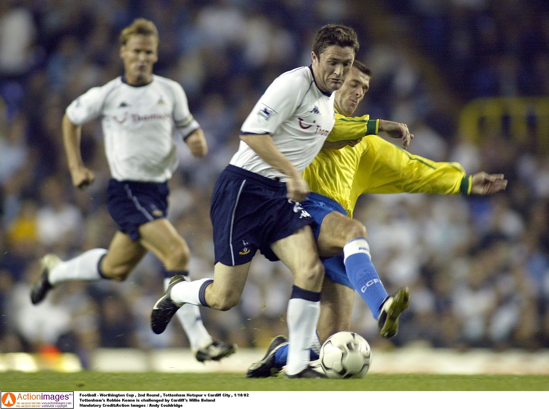 Football - Worthington Cup , 2nd Round , Tottenham Hotspur v Cardiff City , 1/10/02 
Tottenham's Robbie Keane is challenged by Cardiff's Willie Boland 
Mandatory Credit:Action Images / Andy Couldridge