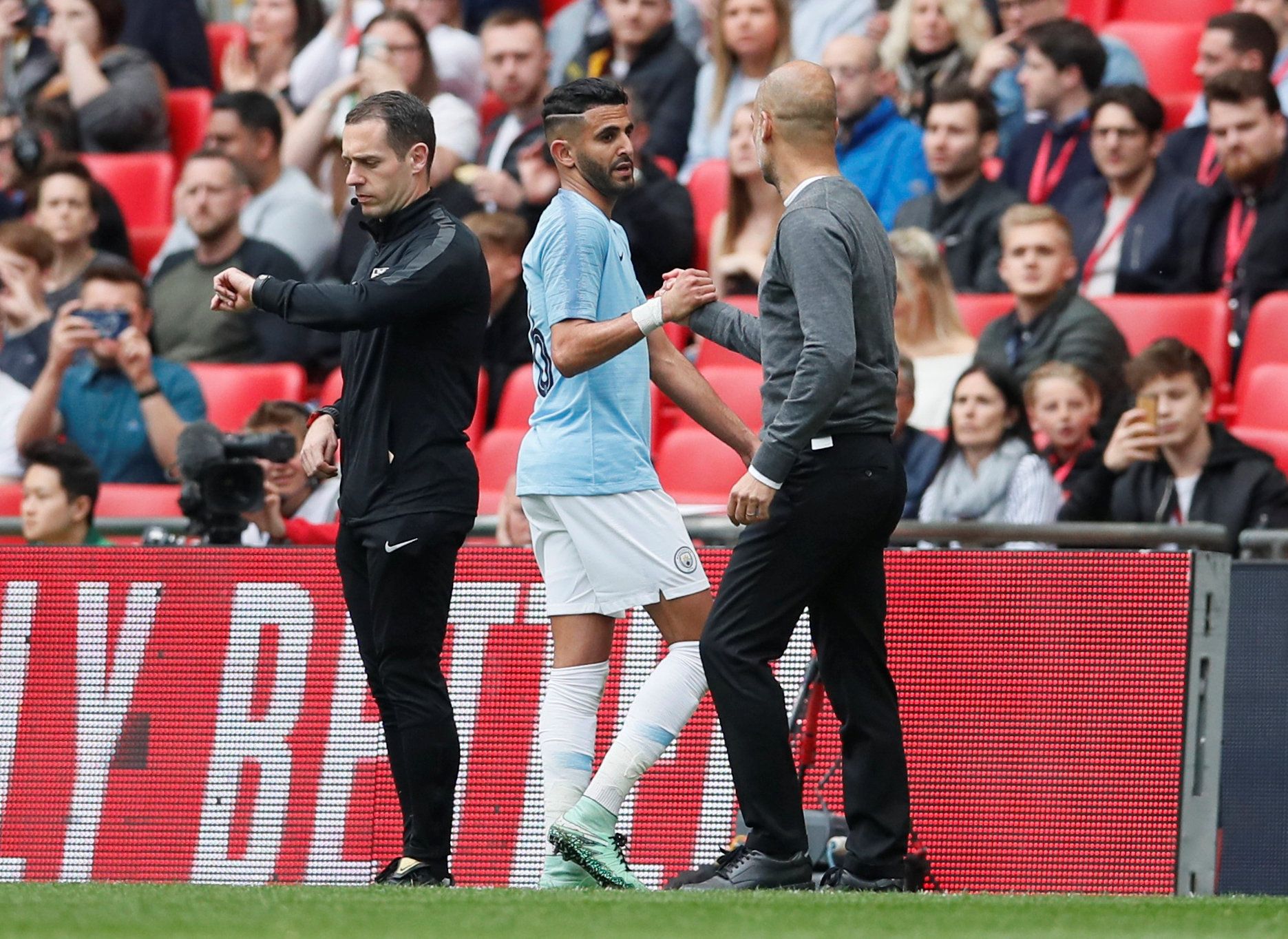 Soccer Football -  FA Cup Final - Manchester City v Watford - Wembley Stadium, London, Britain - May 18, 2019  Manchester City's Riyad Mahrez shakes hands with Manchester City manager Pep Guardiola as he is substituted off      REUTERS/David Klein