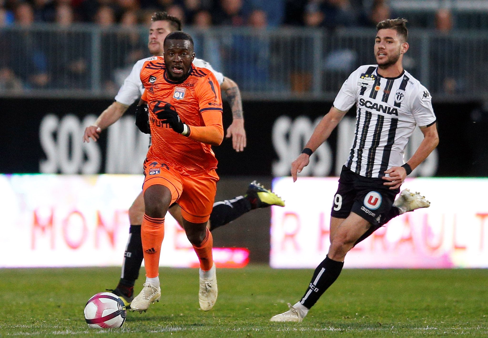 Soccer Football - Ligue 1 - Angers v Olympique Lyonnais - Stade Raymond Kopa, Angers, France - October 27, 2018  Lyon's Tanguy Ndombele in action with Angers' Cristian Lopez                 REUTERS/Stephane Mahe