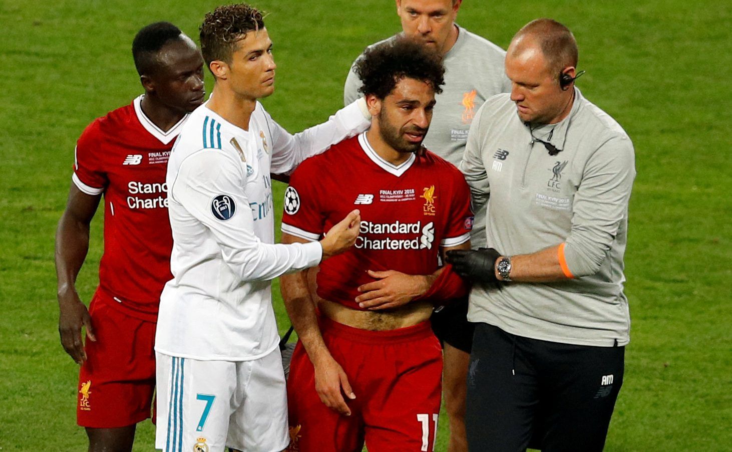 Soccer Football - Champions League Final - Real Madrid v Liverpool - NSC Olympic Stadium, Kiev, Ukraine - May 26, 2018   Liverpool's Mohamed Salah with Sadio Mane and Real Madrid's Cristiano Ronaldo as he is substituted after sustaining an injury   REUTERS/Phil Noble     TPX IMAGES OF THE DAY