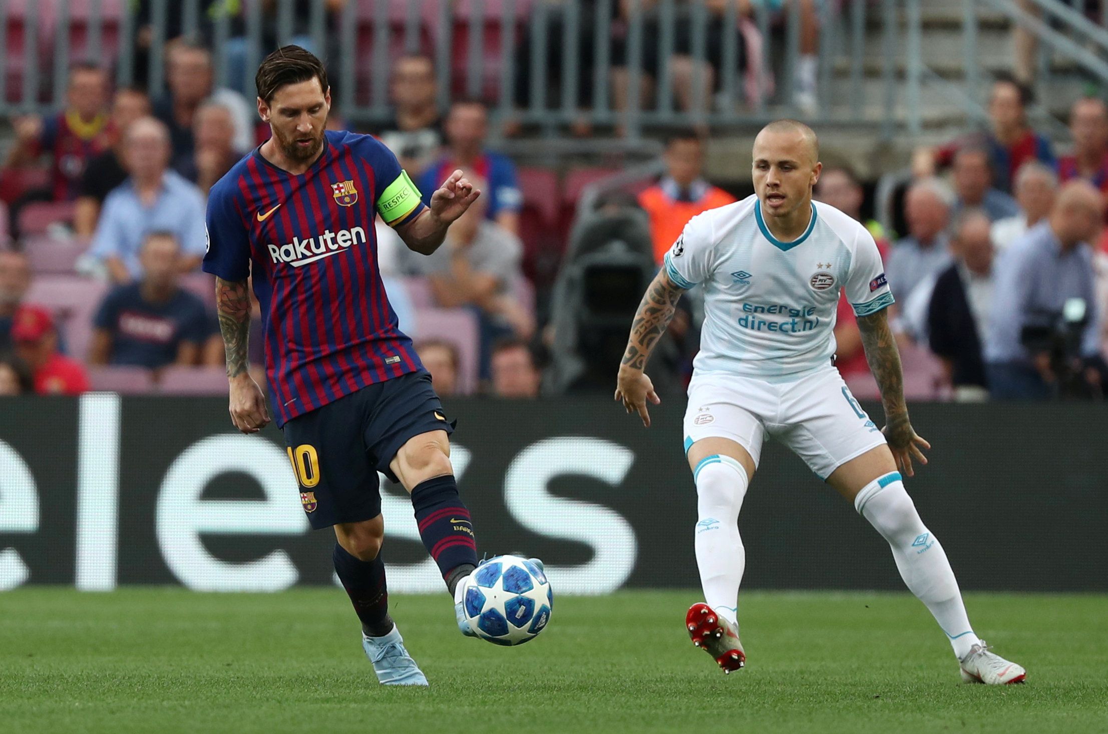 Soccer Football - Champions League - Group Stage - Group B - FC Barcelona v PSV Eindhoven - Camp Nou, Barcelona, Spain - September 18, 2018  Barcelona's Lionel Messi in action with PSV Eindhoven's Angelino  REUTERS/Sergio Perez