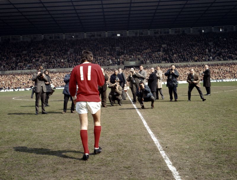 Manchester United footballer George Best faced by photographers and cameramen after he received the European Footballer of the Year Award from French journalist Max Urbini before his side's league division one match against Burnley at Old Trafford
April 1969