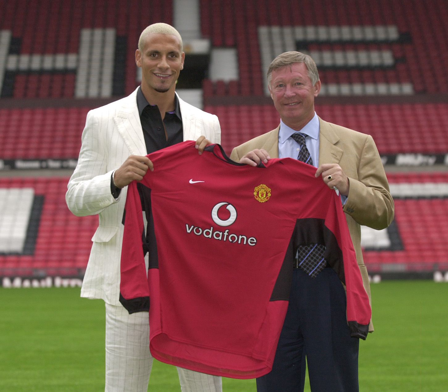 Rio Ferdinand July 2002 Manchester United's new signing walks with manager Alex Ferguson (right) at the club's Old Trafford ground. The 23-year-old former Leeds defender smashed British transfer fee records when he moved across the Pennines to become the sixth most expensive footballer of all time  

Rio signed for £29,100,000.   Only the 3rd player to be over £20m in the uk transfer market.

Picture taken 22nd July 2002