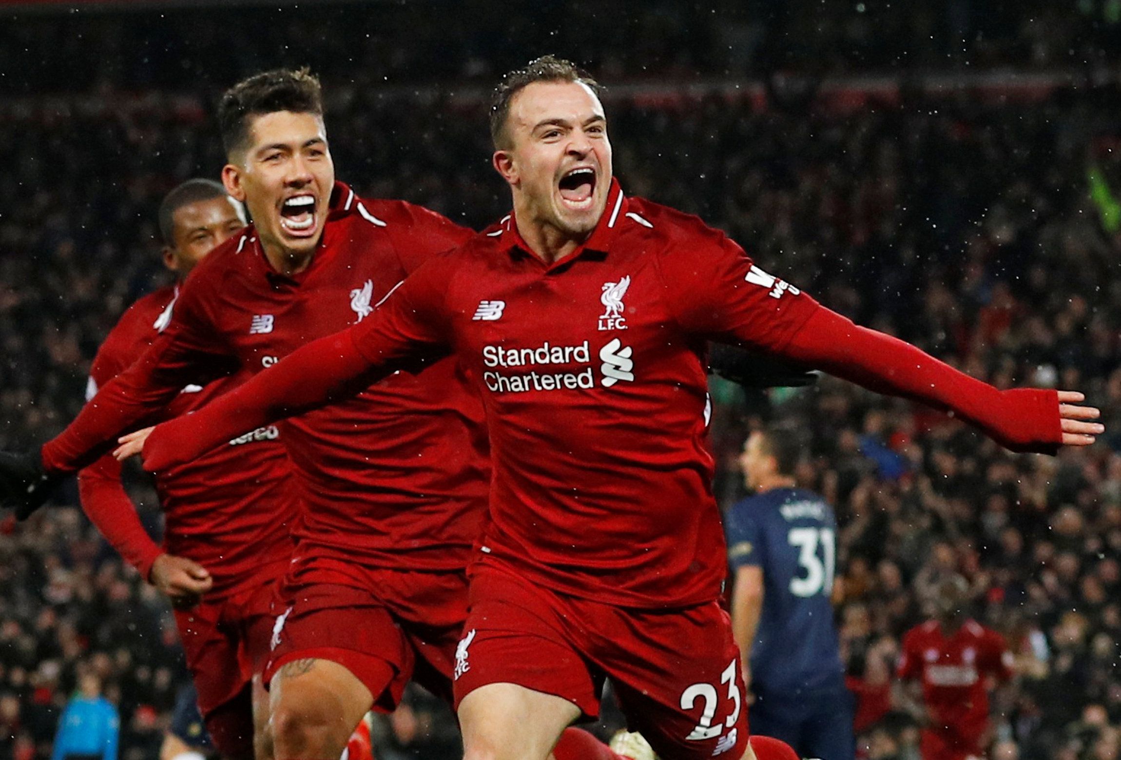 Soccer Football - Premier League - Liverpool v Manchester United - Anfield, Liverpool, Britain - December 16, 2018  Liverpool's Xherdan Shaqiri celebrates scoring their third goal with Roberto Firmino and Georginio Wijnaldum   REUTERS/Phil Noble  EDITORIAL USE ONLY. No use with unauthorized audio, video, data, fixture lists, club/league logos or 