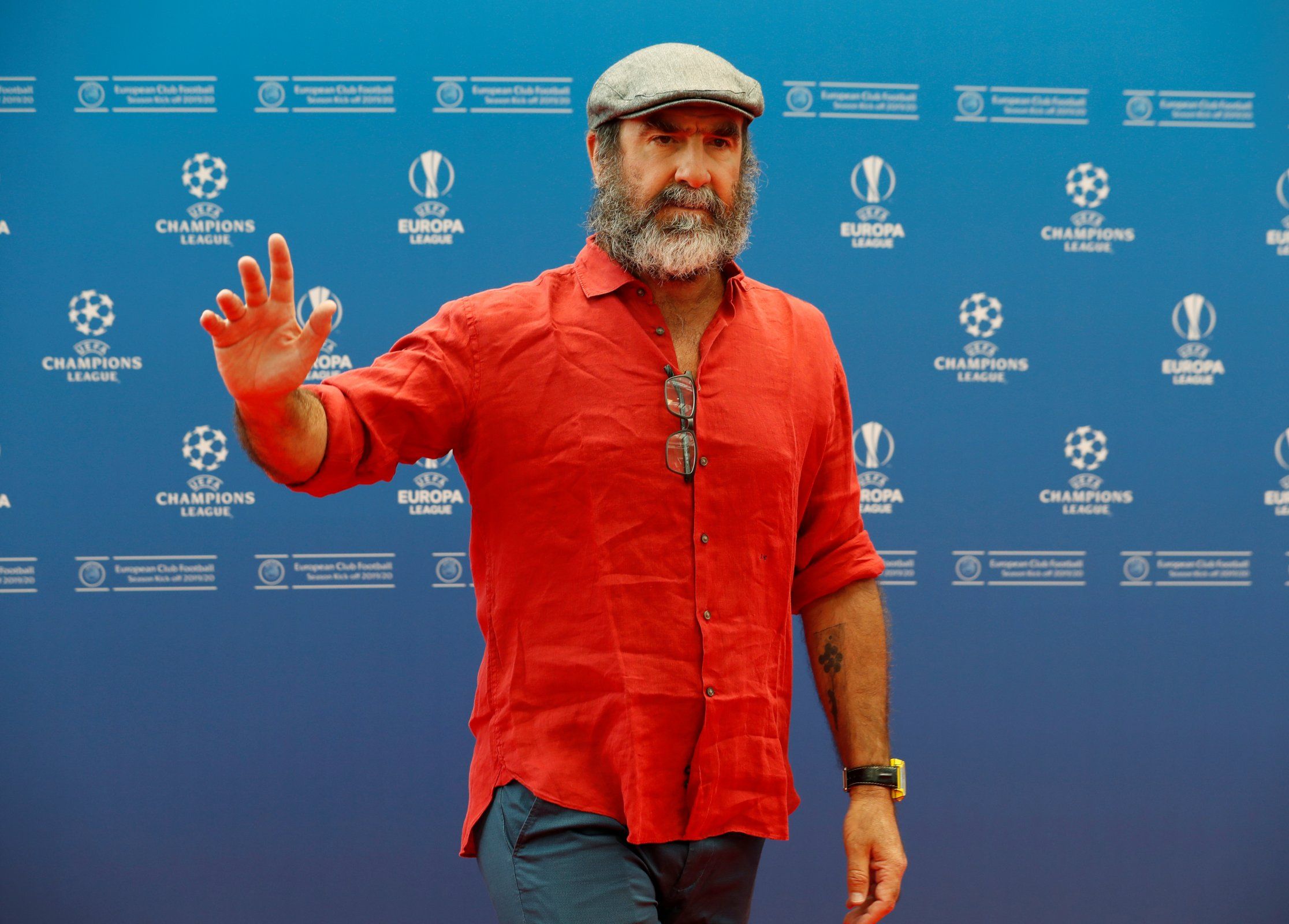 Eric Cantona waving his hand at the Champions League draw