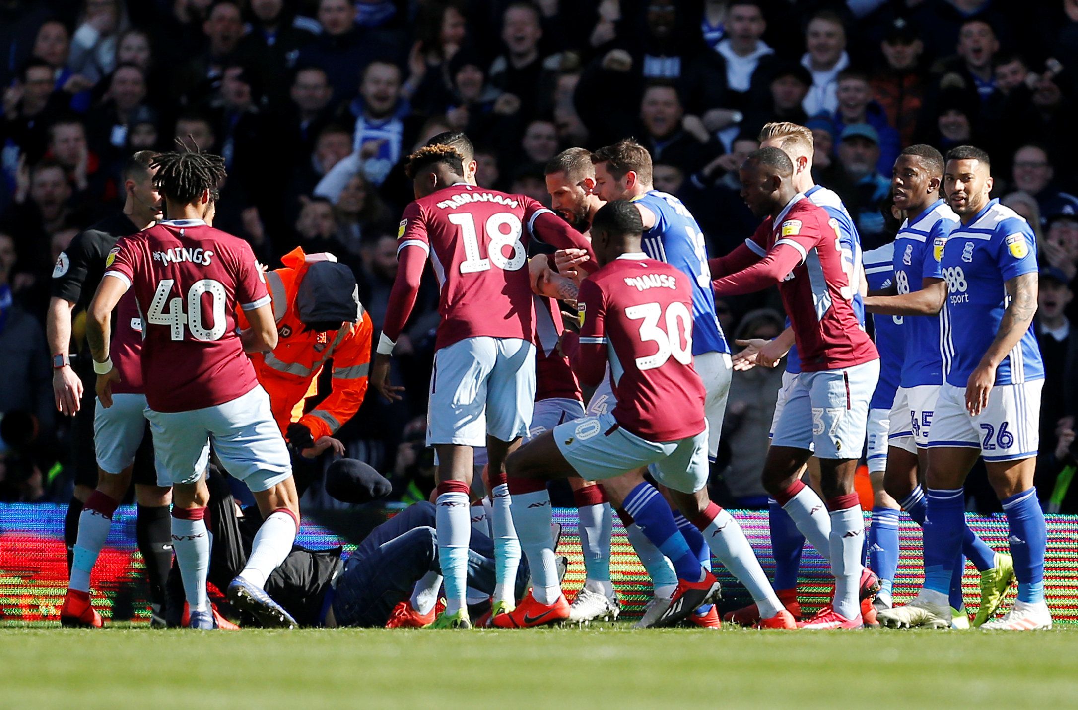 Soccer Football - Championship - Birmingham City v Aston Villa - St Andrew's, Birmingham, Britain - March 10, 2019   Aston Villa players react after a fan invades the pitch and attacks Jack Grealish   Action Images via Reuters/Craig Brough    EDITORIAL USE ONLY. No use with unauthorized audio, video, data, fixture lists, club/league logos or 