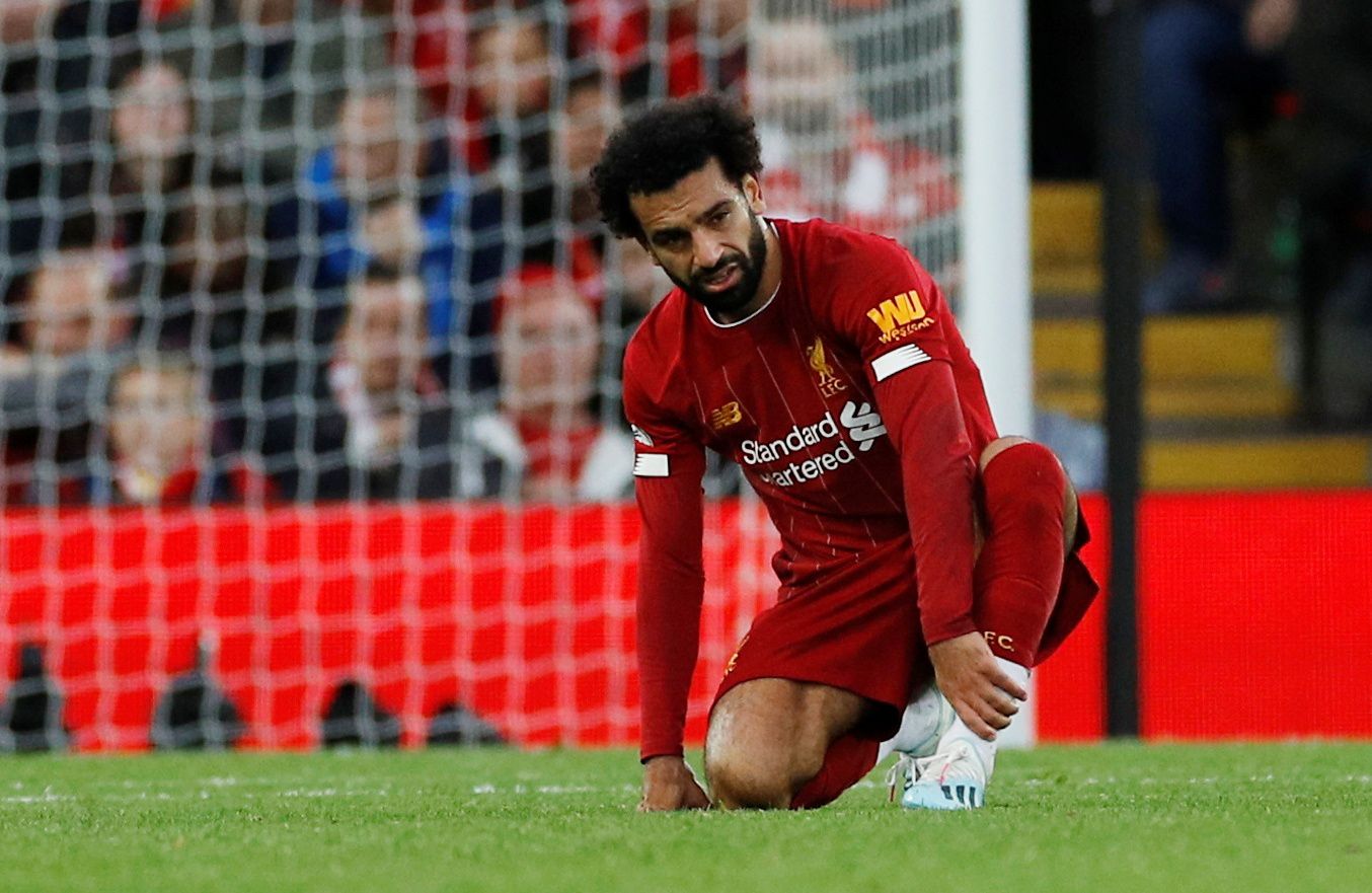 Soccer Football - Premier League - Liverpool v Leicester City - Anfield, Liverpool, Britain - October 5, 2019  Liverpool's Mohamed Salah reacts after sustaining an injury REUTERS/Phil Noble  EDITORIAL USE ONLY. No use with unauthorized audio, video, data, fixture lists, club/league logos or 