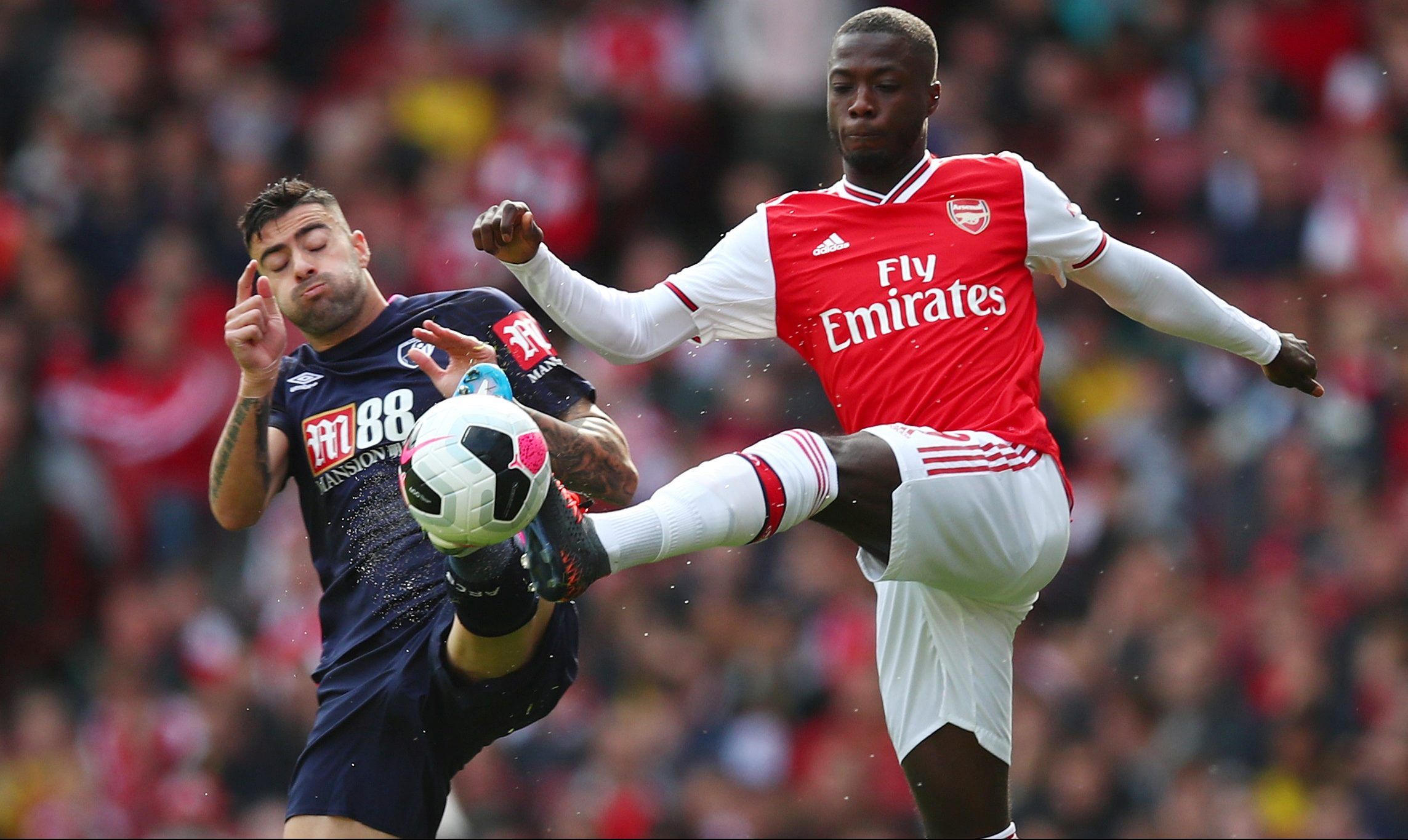 Soccer Football - Premier League - Arsenal v AFC Bournemouth - Emirates Stadium, London, Britain - October 6, 2019  Arsenal's Nicolas Pepe in action with Bournemouth's Diego Rico      REUTERS/Eddie Keogh  EDITORIAL USE ONLY. No use with unauthorized audio, video, data, fixture lists, club/league logos or 