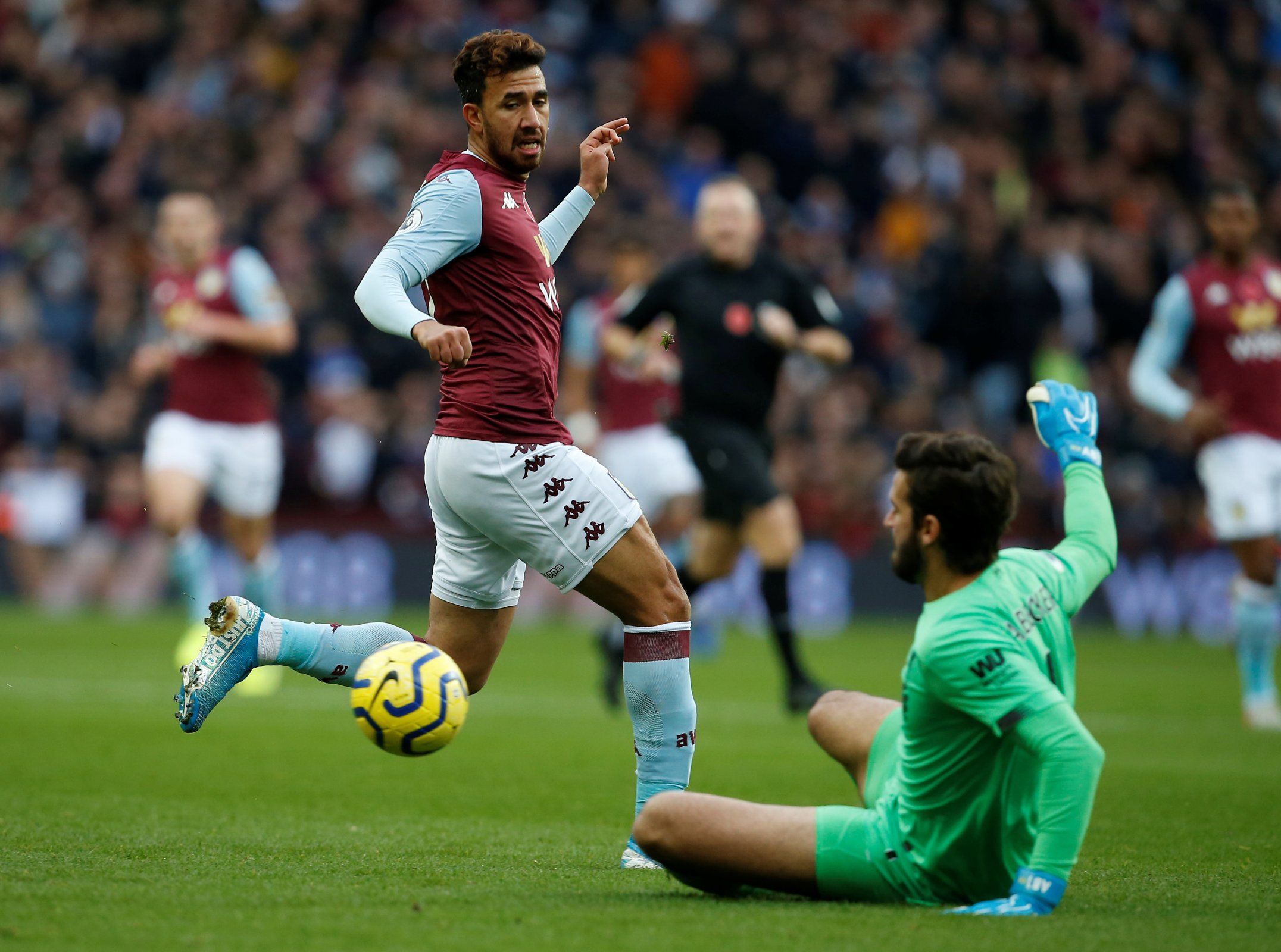 Aston Villa's Trezeguet in action with Liverpool's Alisson