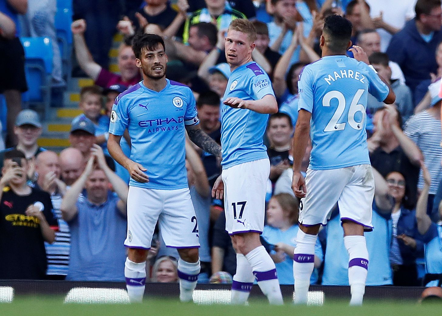 Soccer Football - Premier League - Manchester City v Watford - Etihad Stadium, Manchester, Britain - September 21, 2019  Manchester City's Kevin De Bruyne celebrates scoring their eighth goal with teammates David Silva and Riyad Mahrez   Action Images via Reuters/Jason Cairnduff  EDITORIAL USE ONLY. No use with unauthorized audio, video, data, fixture lists, club/league logos or 