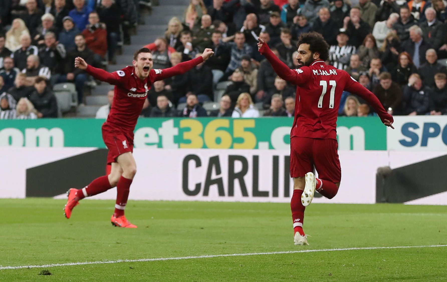 Soccer Football - Premier League - Newcastle United v Liverpool - St James' Park, Newcastle, Britain - May 4, 2019   Liverpool's Mohamed Salah celebrates scoring their second goal with Andrew Robertson    Action Images via Reuters/Lee Smith    EDITORIAL USE ONLY. No use with unauthorized audio, video, data, fixture lists, club/league logos or 